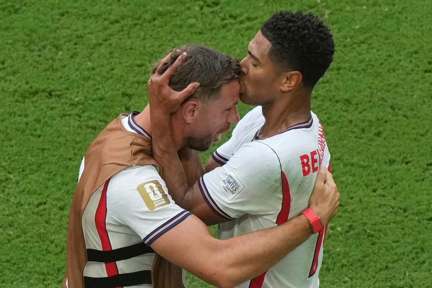 England’s Jude Bellingham kisses Jordan Henderson on the head