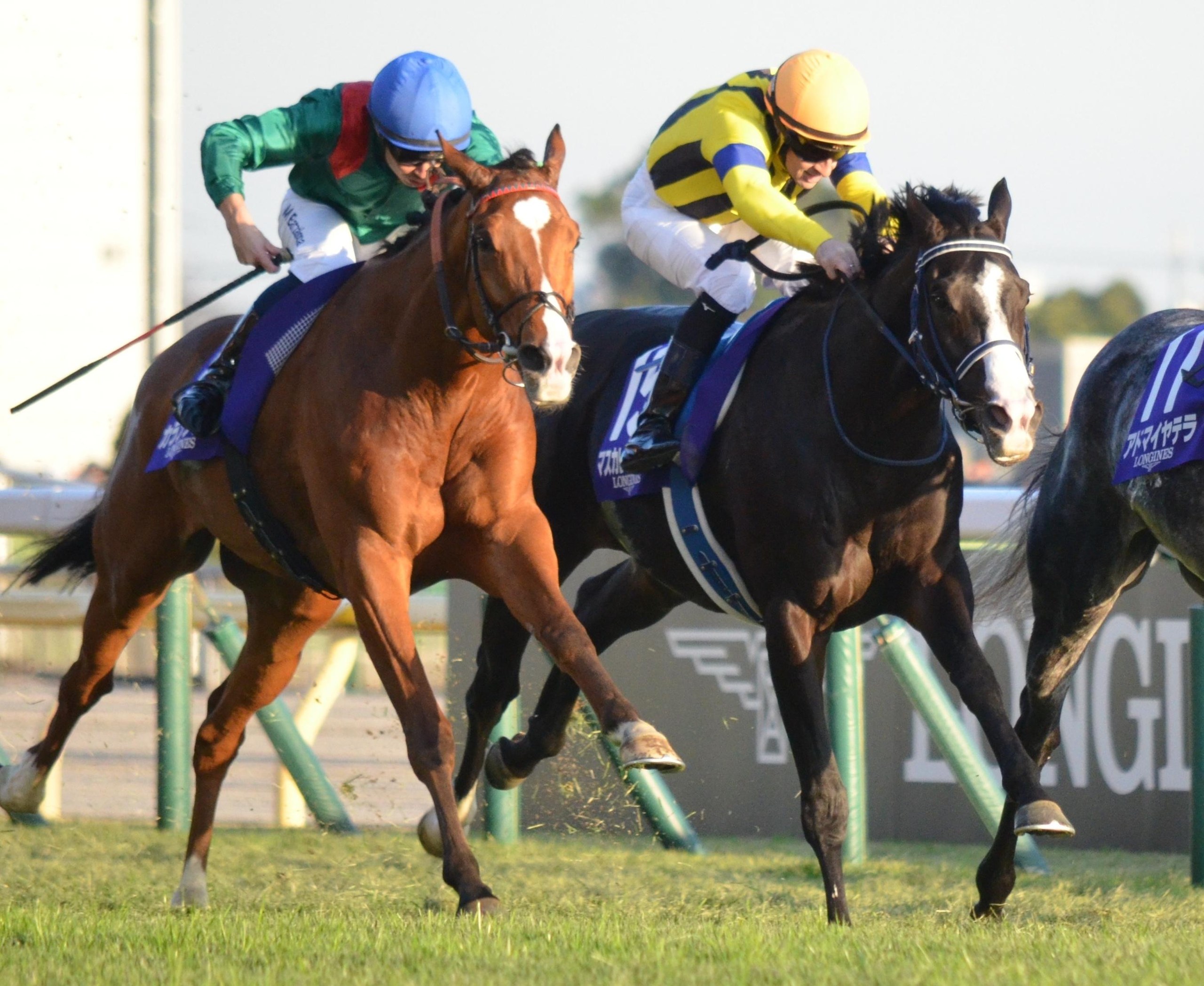 Calandagan, left, holds off Masquerade Ball, the runner-up, in the Japan Cup.