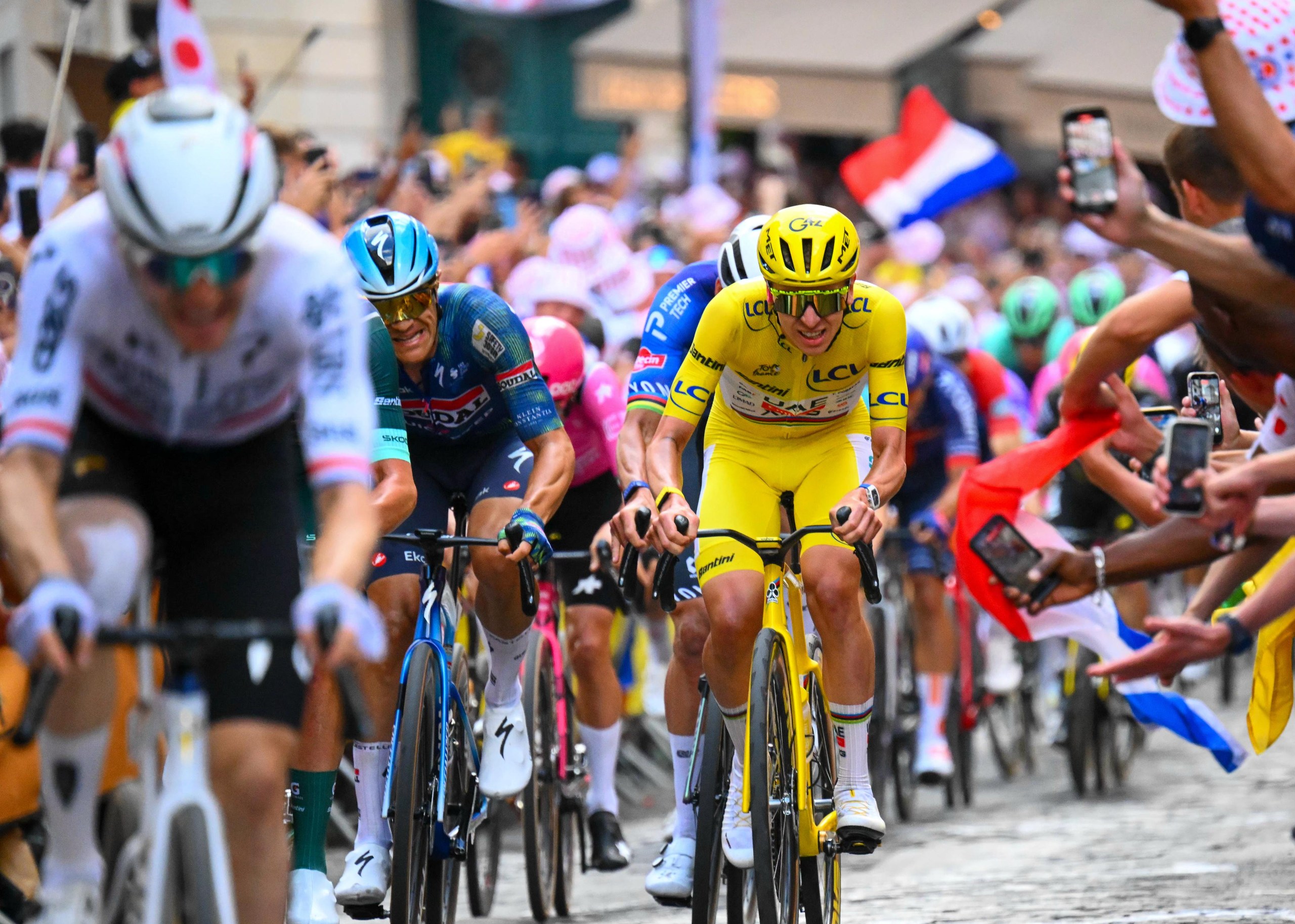 Yellow jersey holder Tadej Pogacar accelerates up the climb of Montmartre to catch Fred Wright.