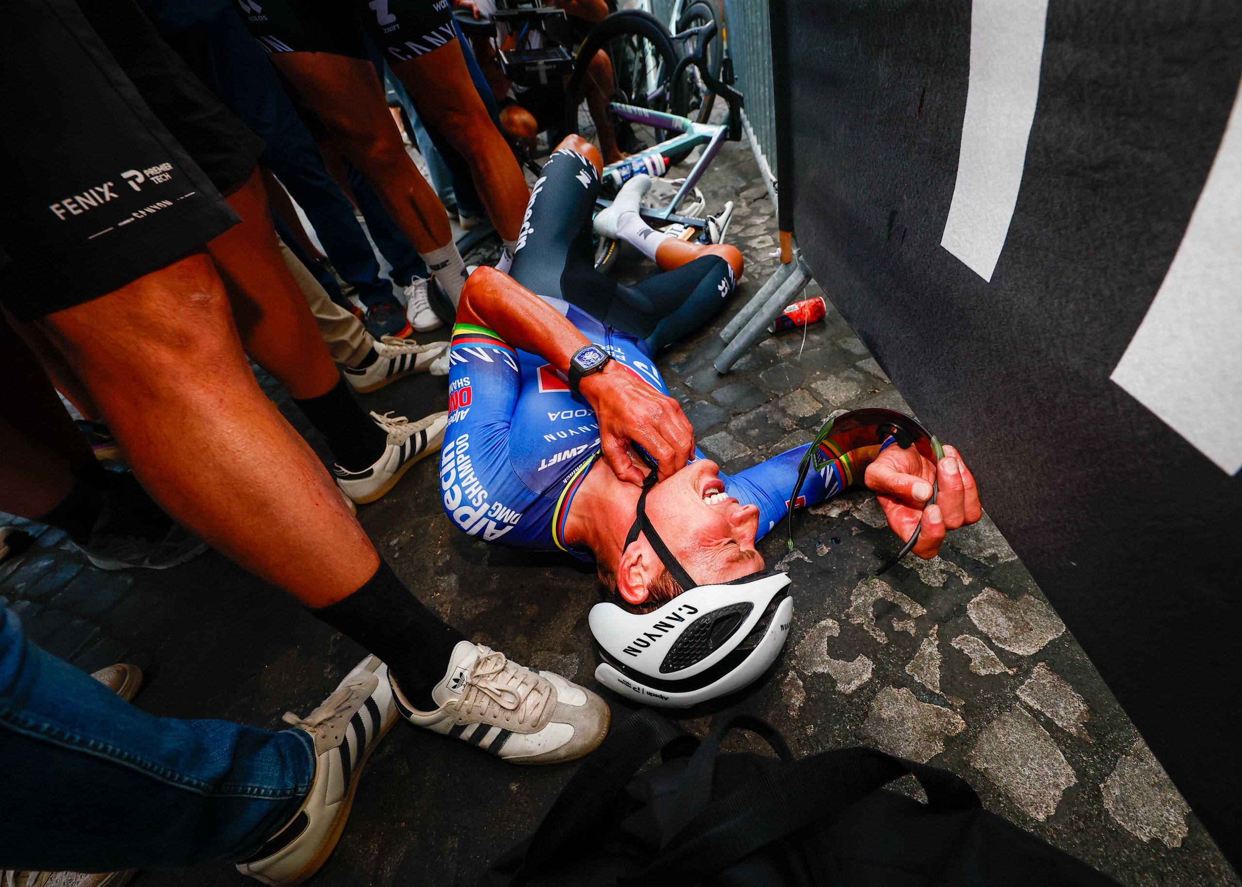 Mathieu van der Poel collapsed after his all out effort to win the final stage on the Champs-Élysées.
