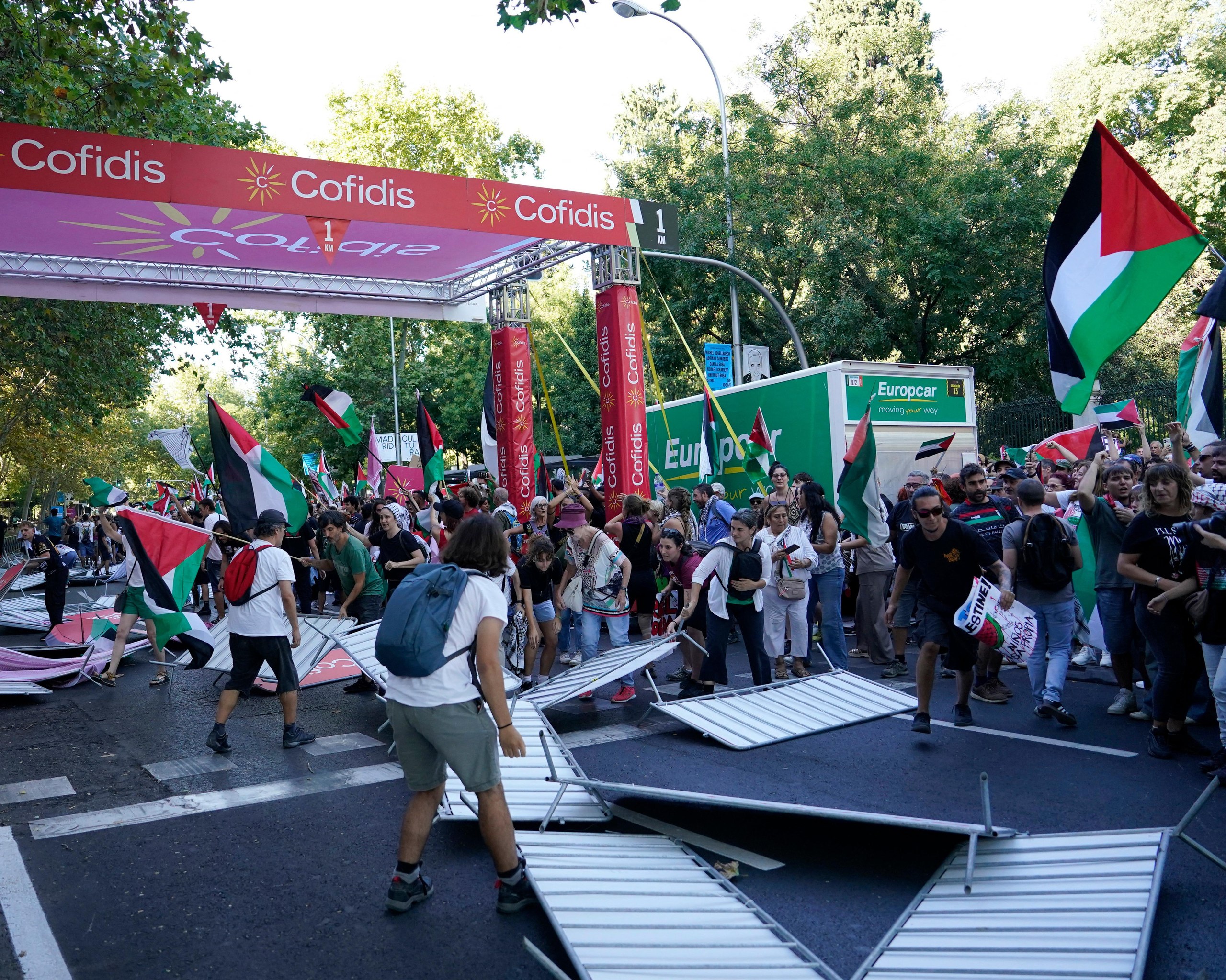 Barriers are smashed by pro Palestine protesters at the finish line of the final stage in Madrid.
