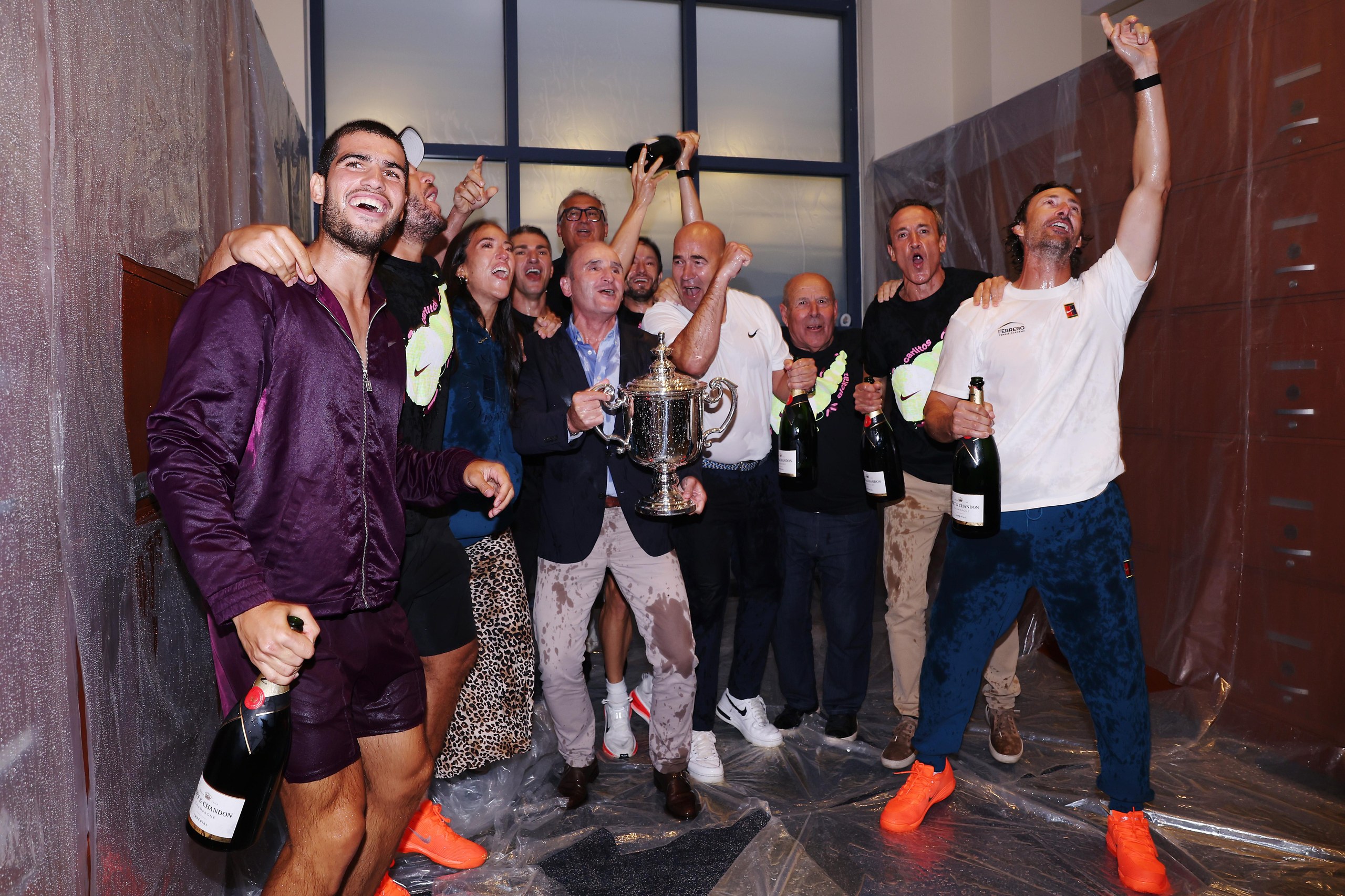 Carlos Alcaraz with his team and family after defeating Jannik Sinner in New York