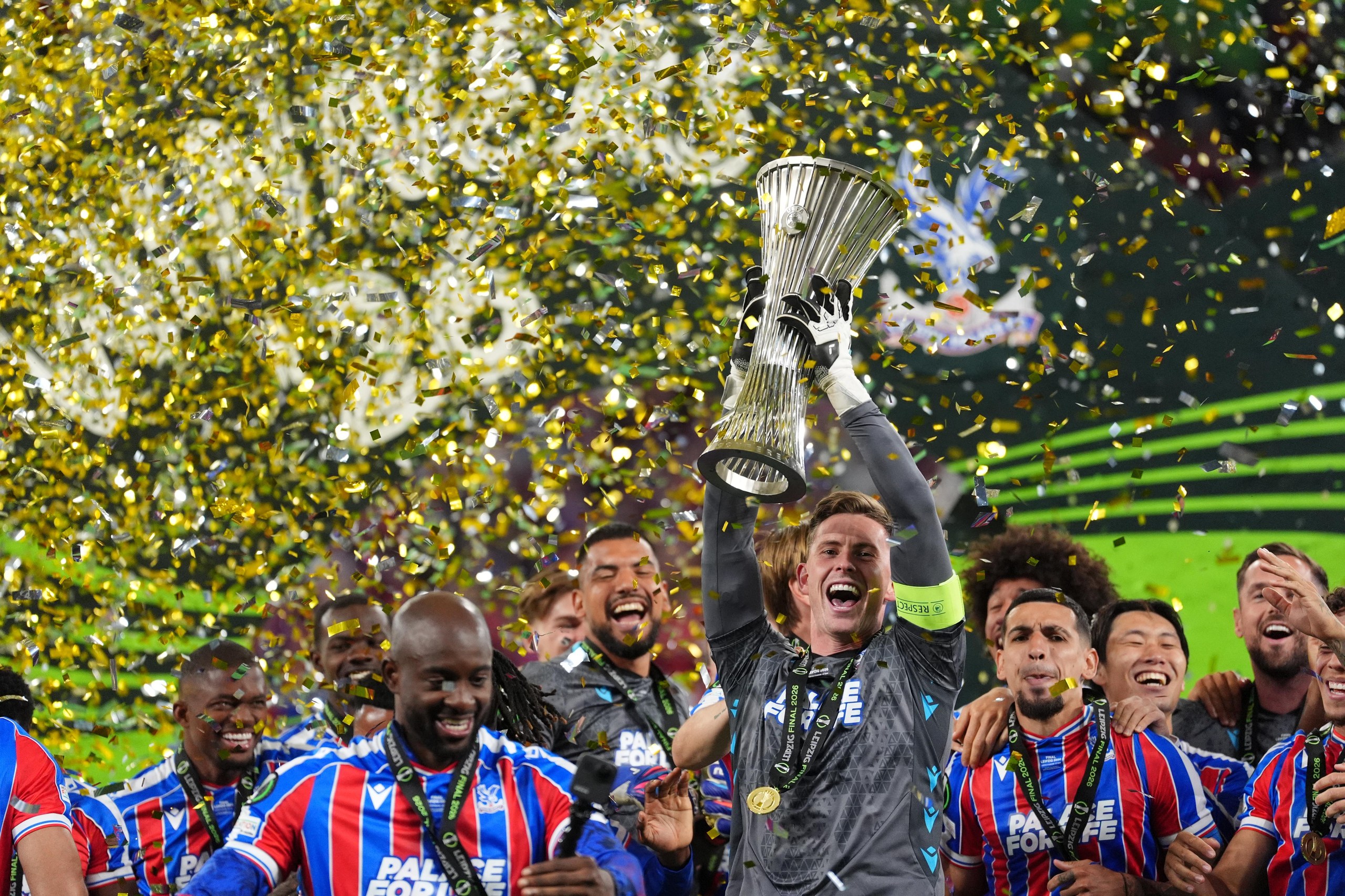 Crystal Palace goalkeeper Dean Henderson lifts the trophy with team-mates after victory over Rayo Vallecano in the UEFA Europa Conference League final.