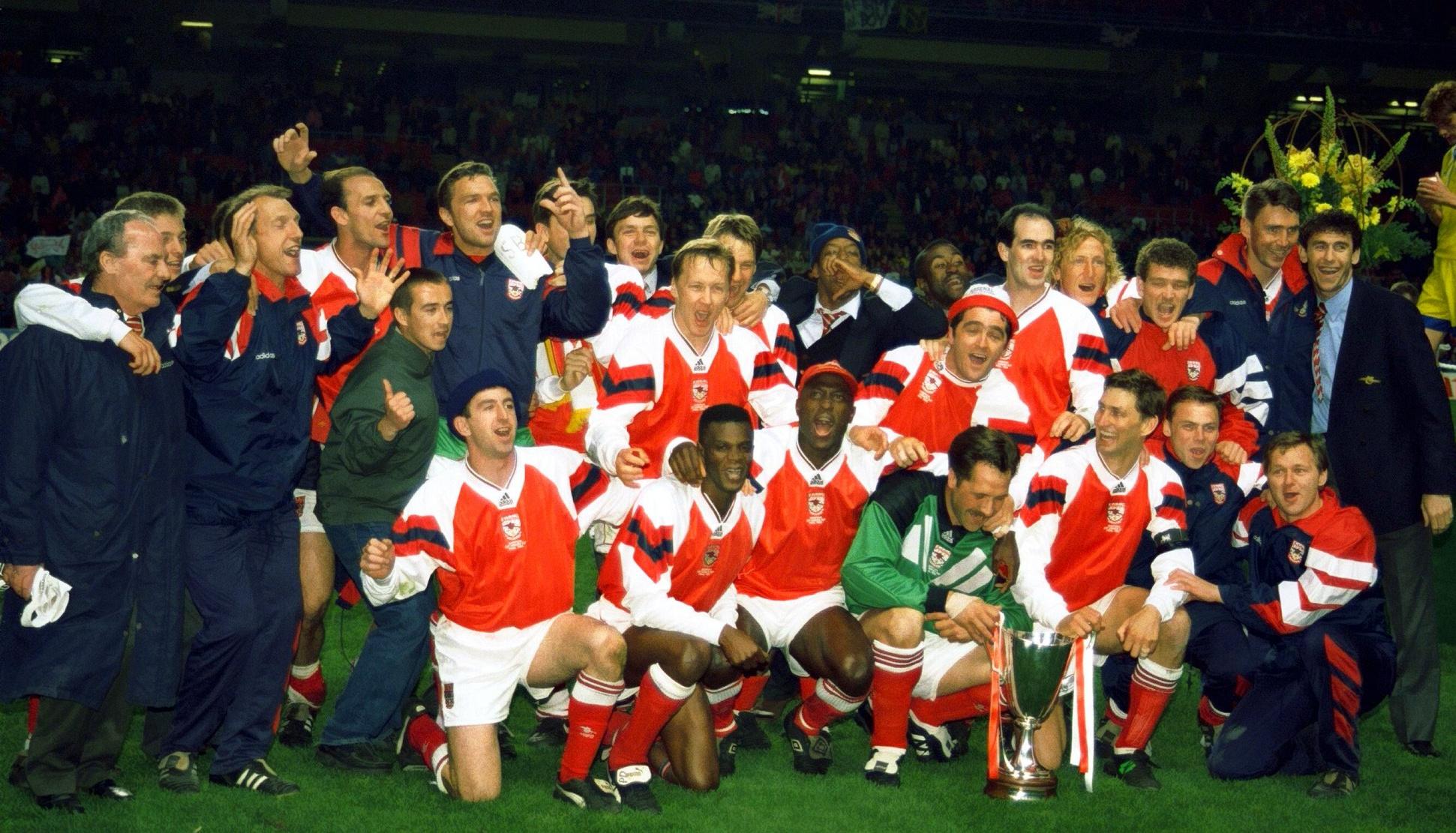 The Arsenal players line up with the trophy.