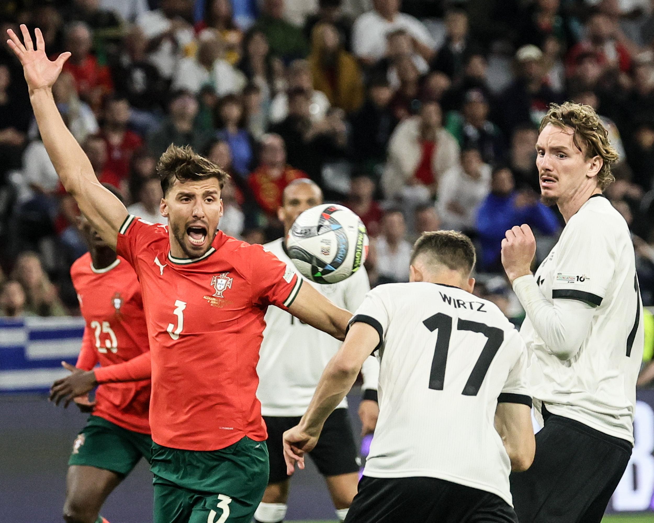 Rúben Dias appeals for a foul as Florian Wirtz heads Germany in front.