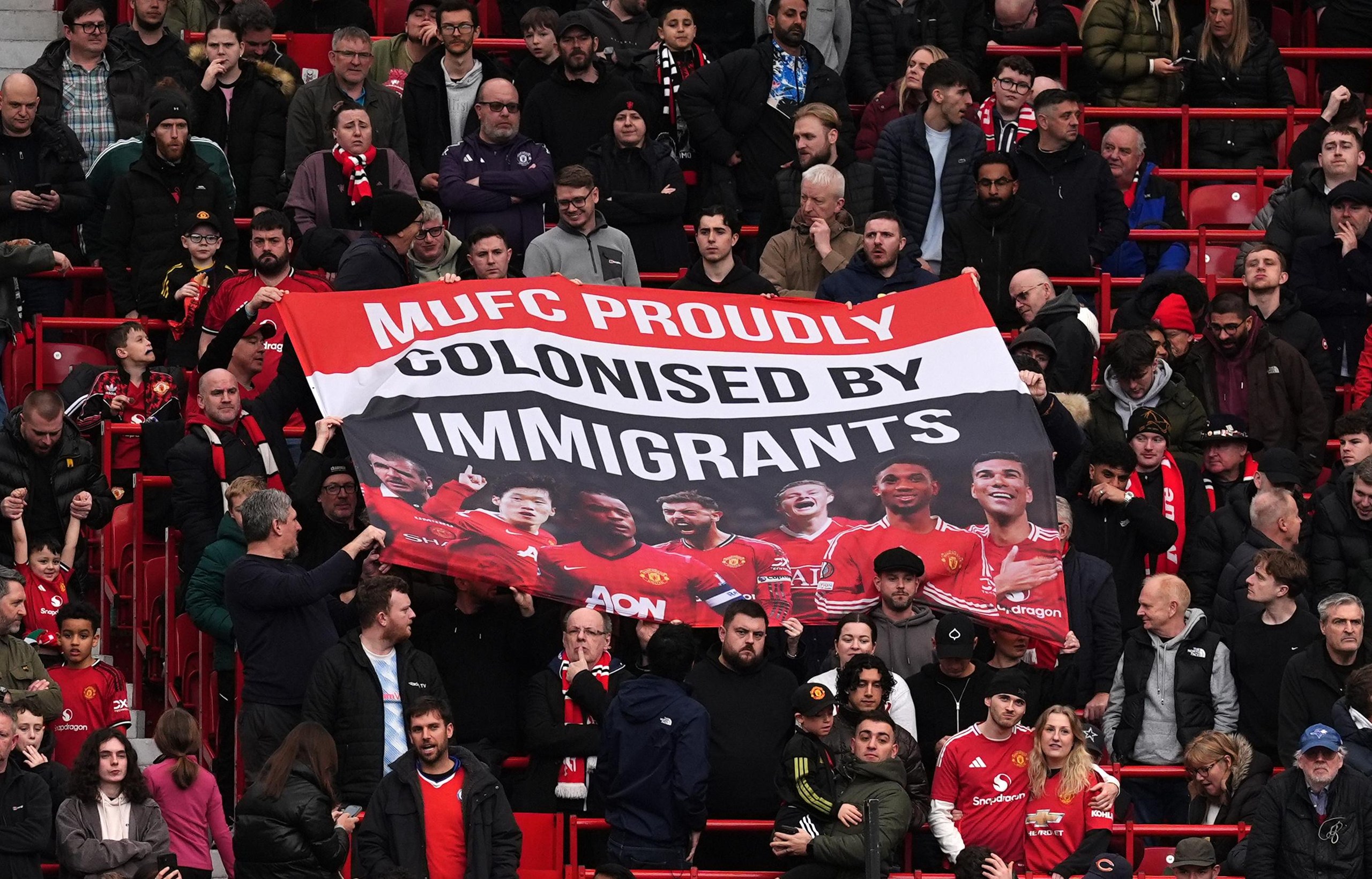 Manchester United fans display a banner