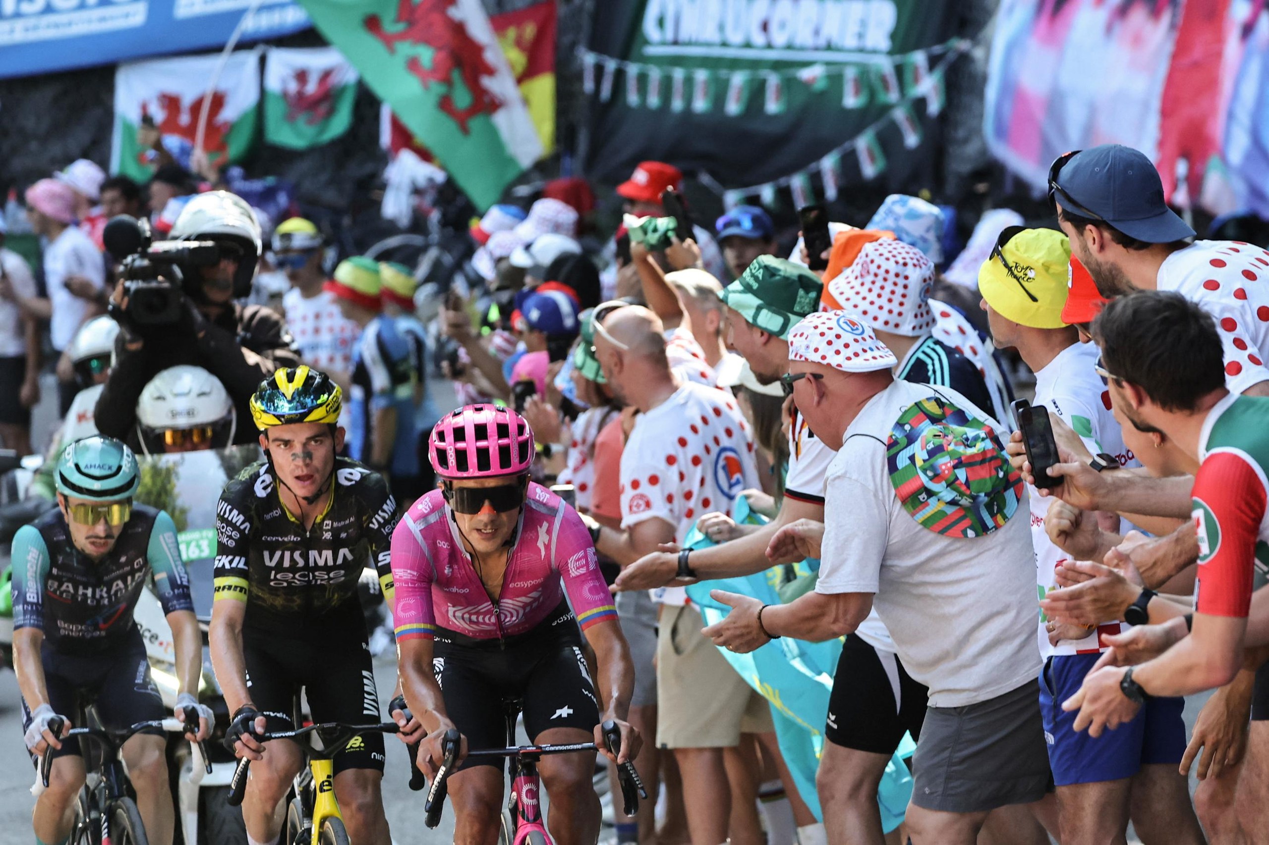 EF Education - EasyPost’s Richard Carapaz (right), Team Visma | Lease a Bike's Sepp Kuss (centre) and Bahrain - Victorious team's Lenny Martinez (left) cycle in the lead breakaway in the Alpe d'Huez ascent.