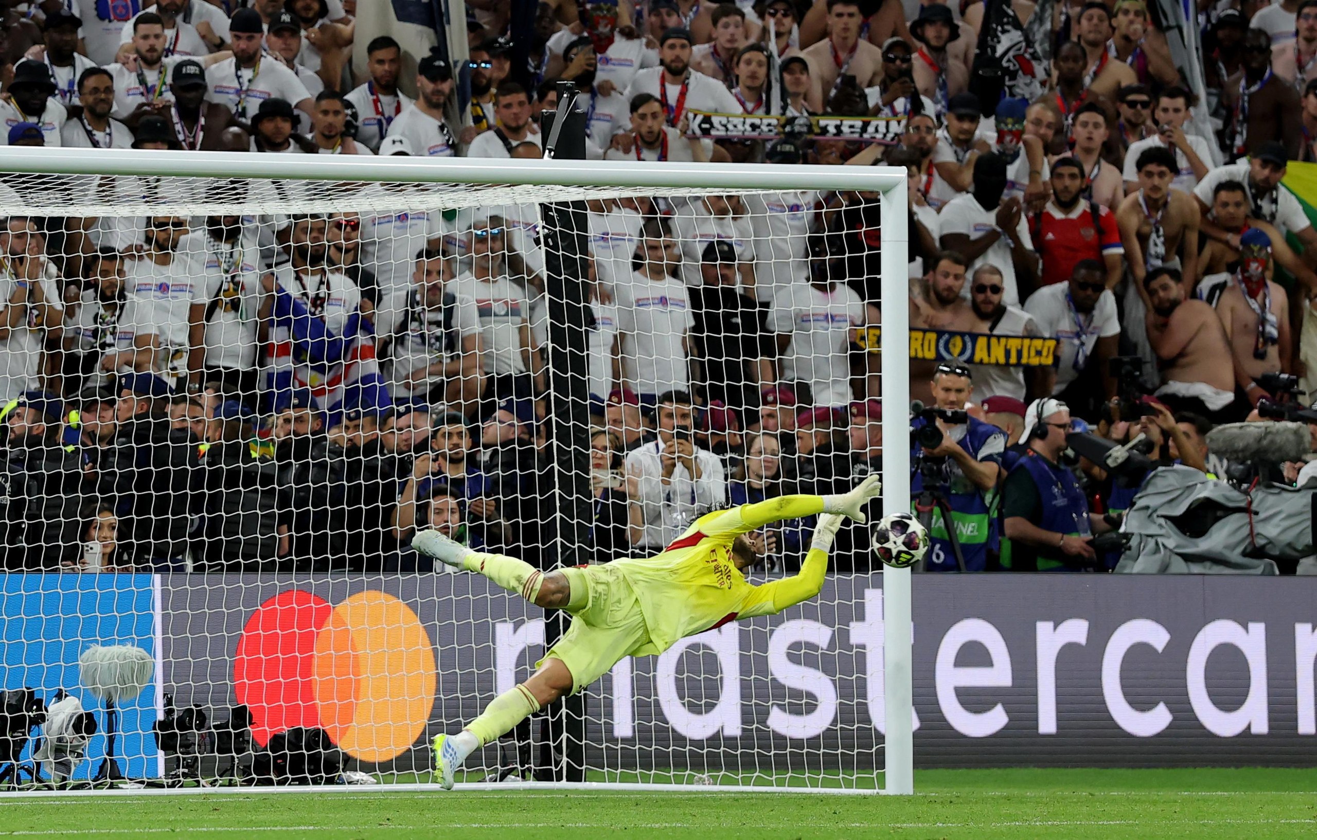 Arsenal's David Raya saves a penalty from Paris St Germain's Nuno Mendes during the penalty shoot-out.