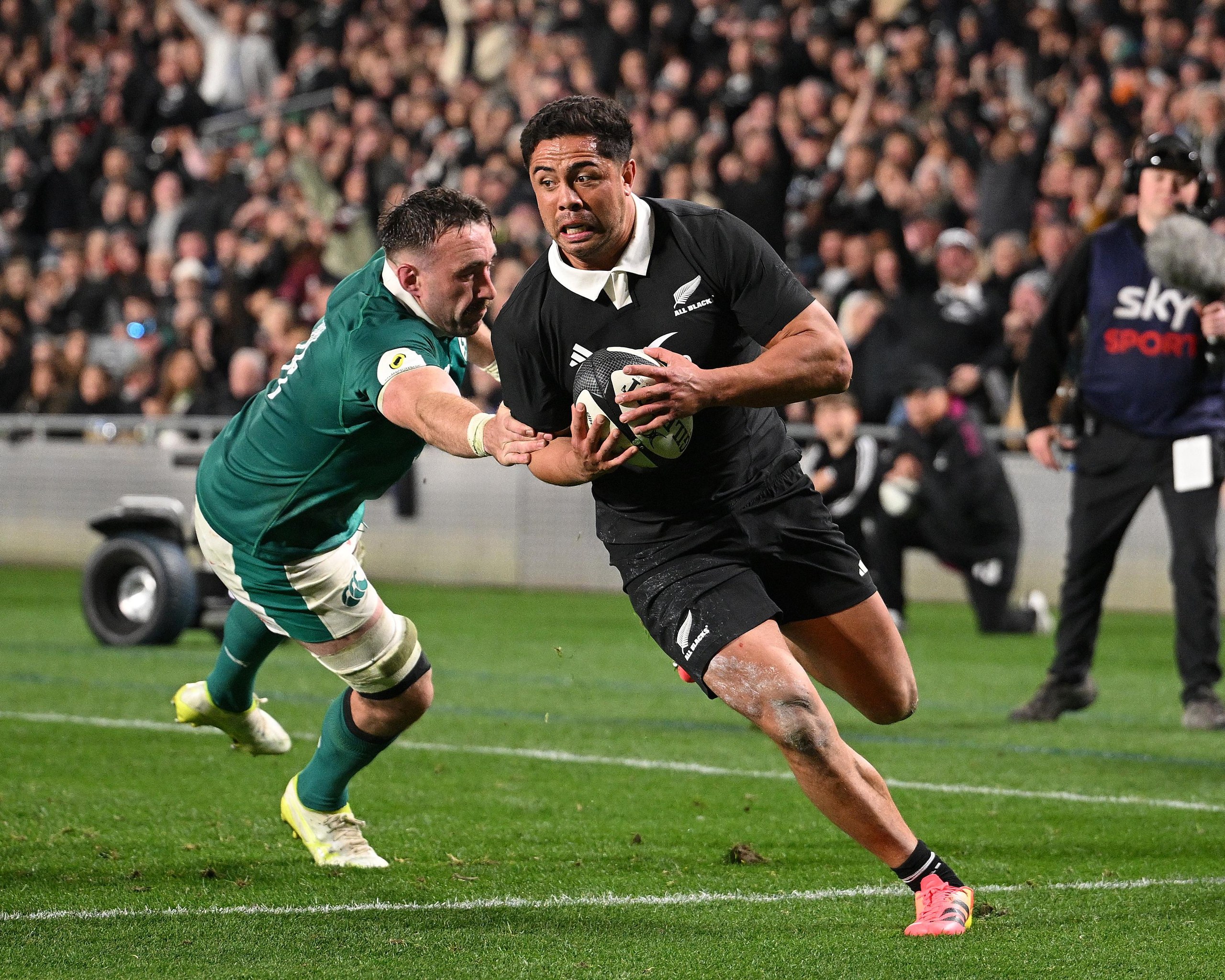 Anton Lienert-Brown runs in a try past the diving tackle from Jack Conan during the Nations Championship rugby Test at Eden Park
