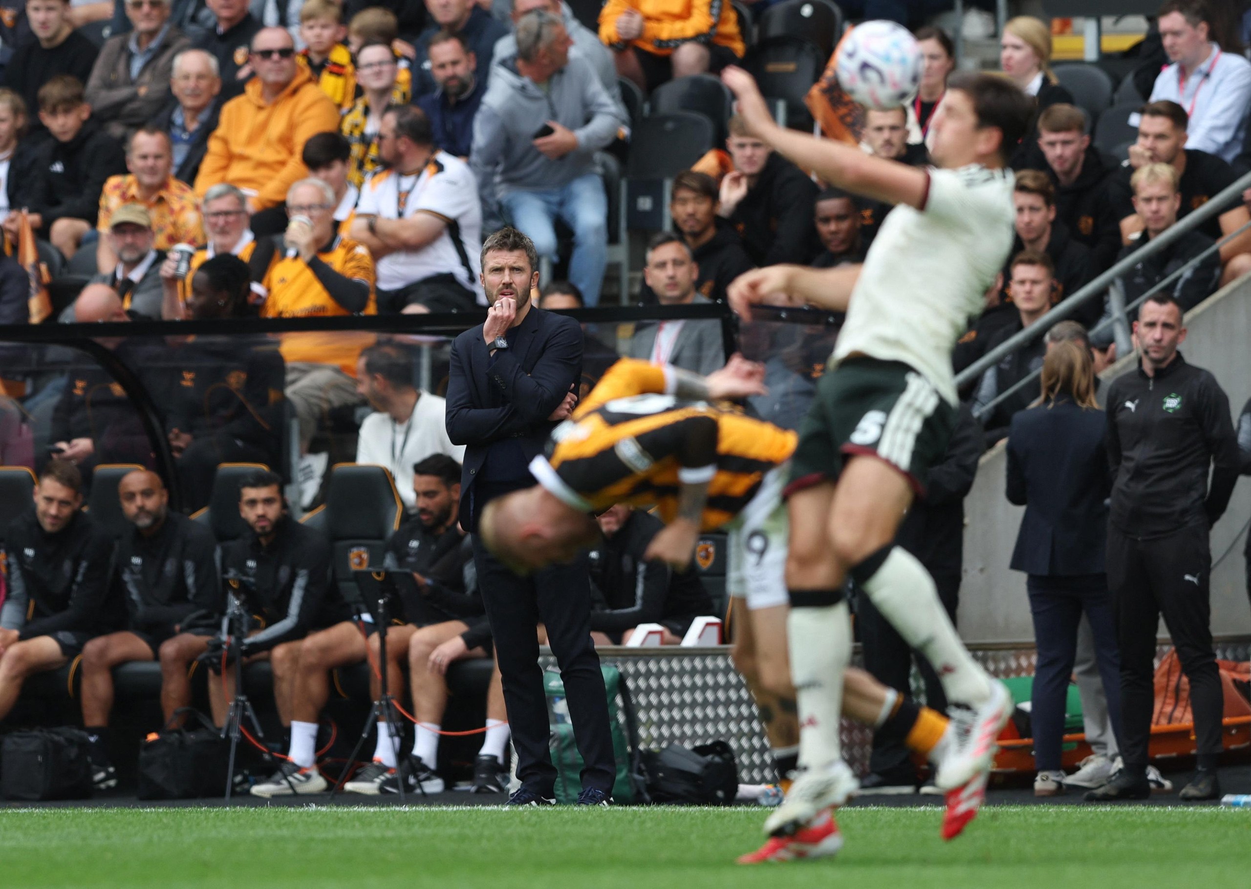 Manchester United manager Michael Carrick watches on as Harry Maguire is in action with Hull City's Oli McBurnie.