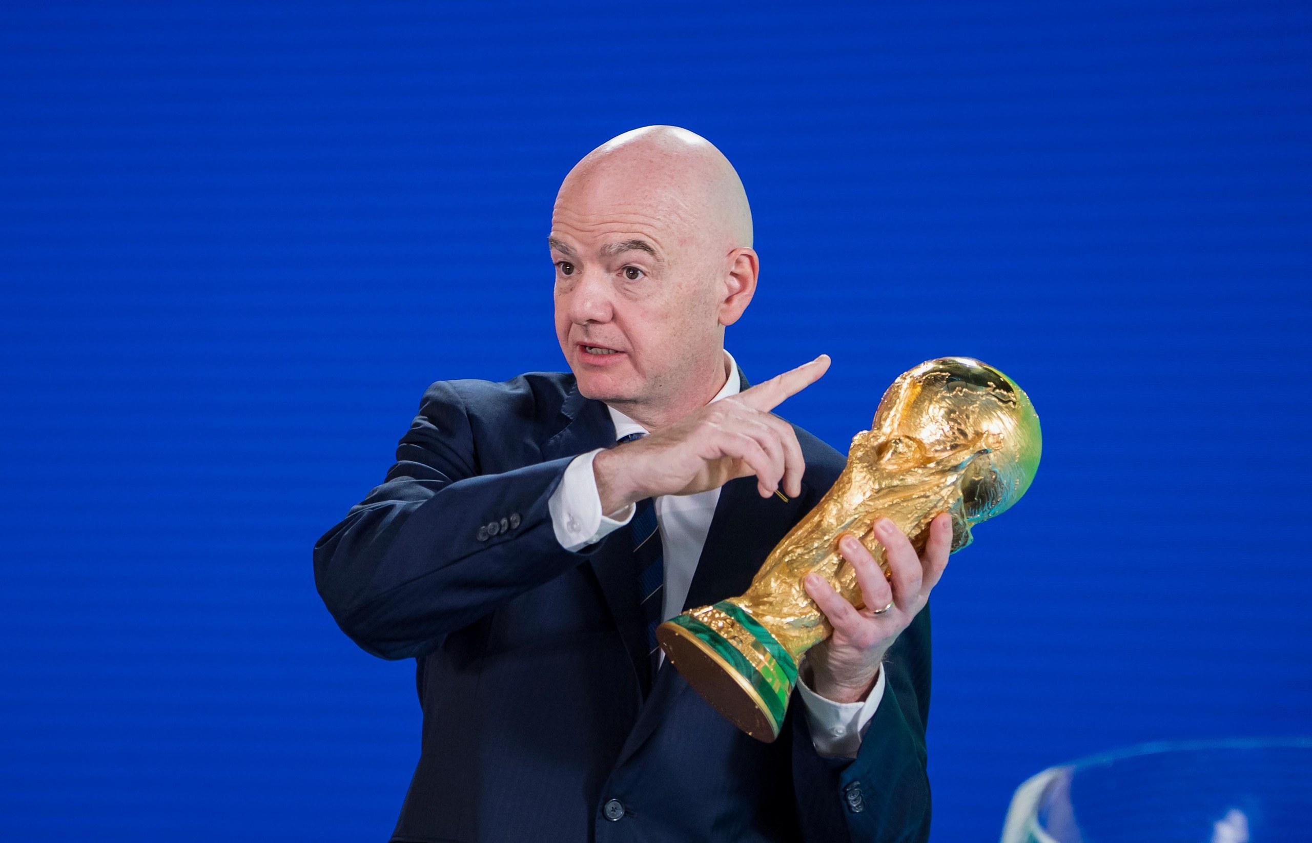 Gianni Infantino holds the World Cup trophy