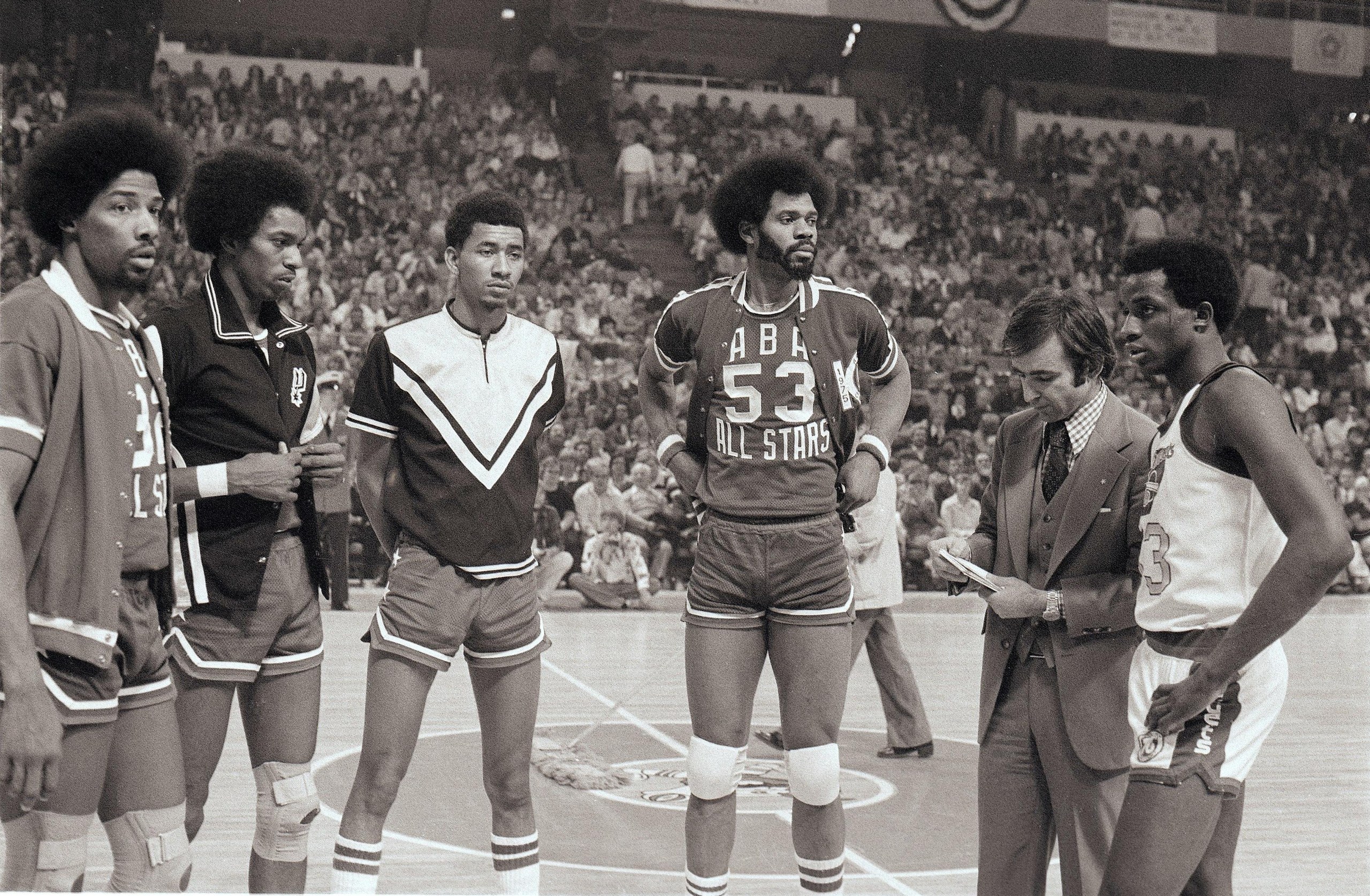 Julius Erving (32), Larry Kenon (35), George Gervin (44), Artis Gilmore (53) and David Thompson (33) look on before the 1976 ABA slam dunk contest in Denver.