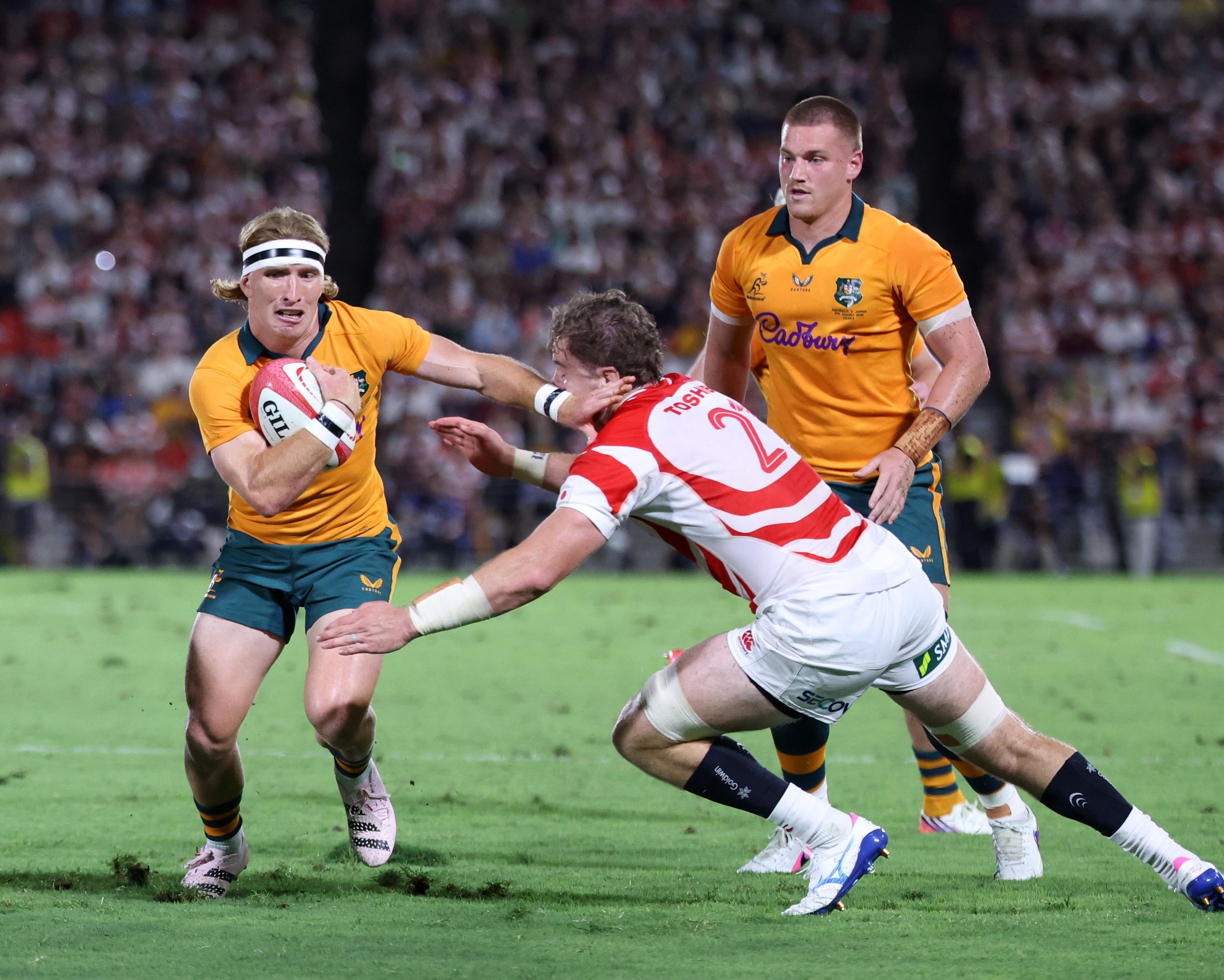 Tate McDermott charges with the ball against Japan’s Tiennan Costley