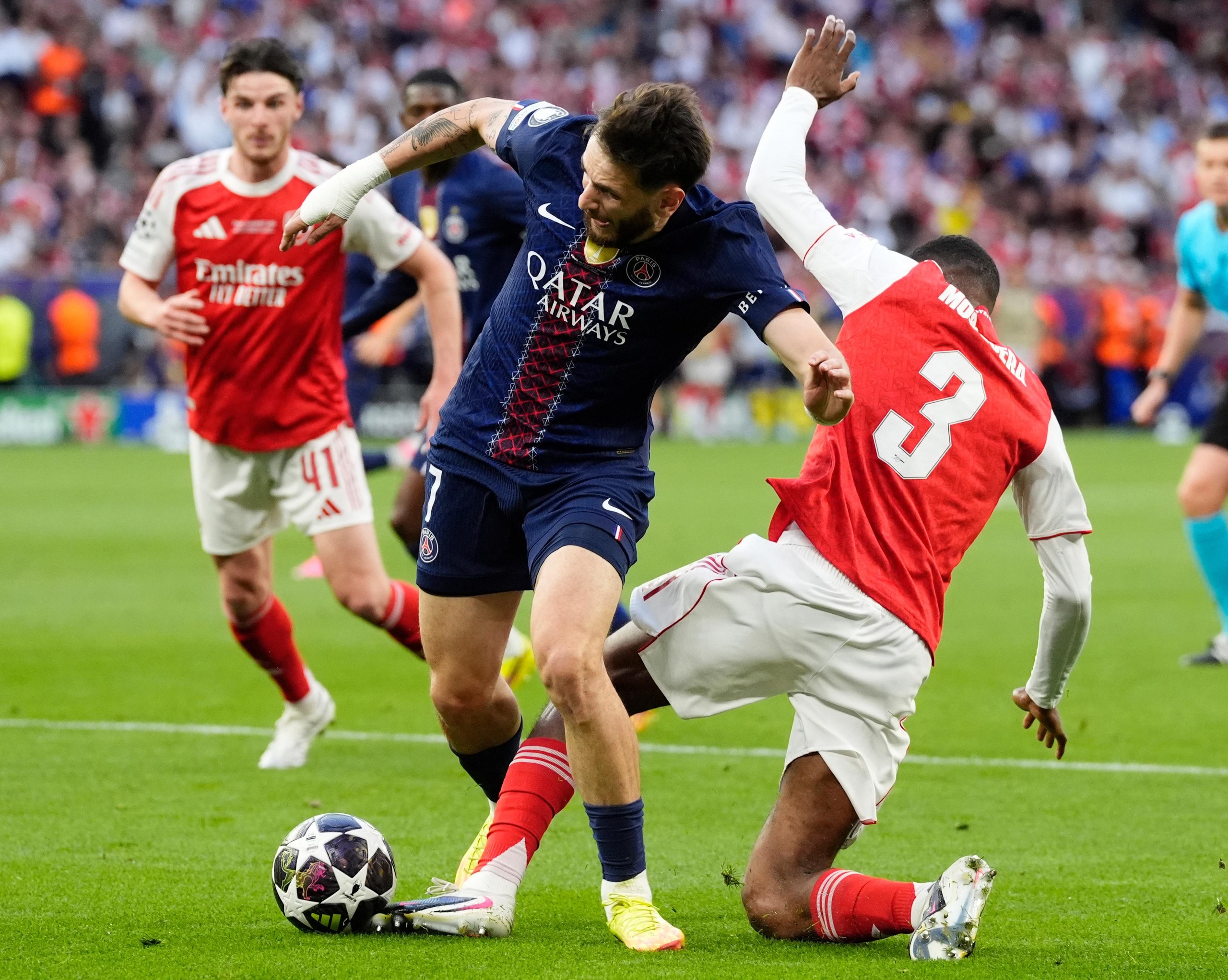 Paris Saint-Germain’s Khvicha Kvaratskhelia (left) is fouled by Arsenal’s Cristhian Mosquera resulting in a penalty