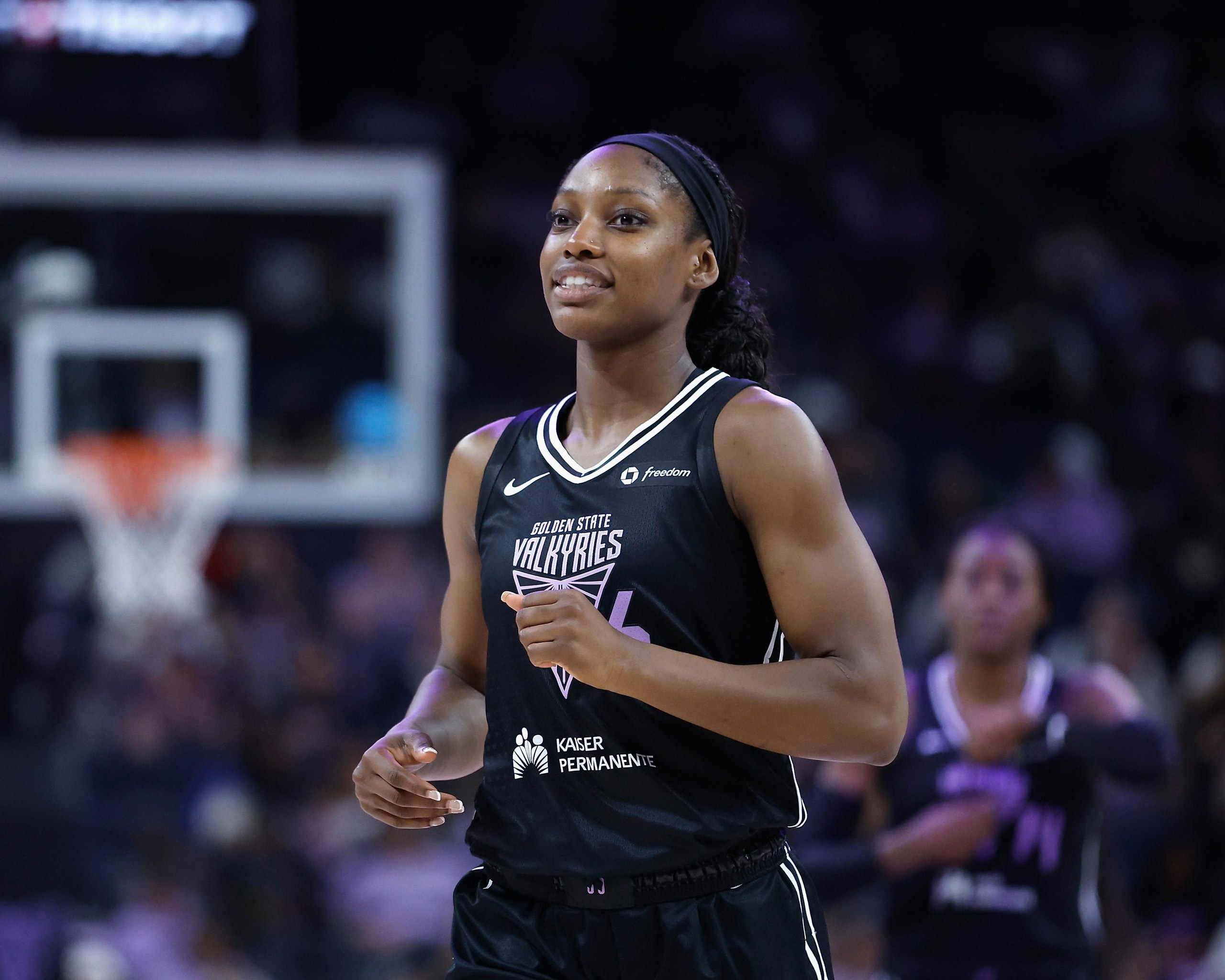 Woman in black jersey with hoop behind her