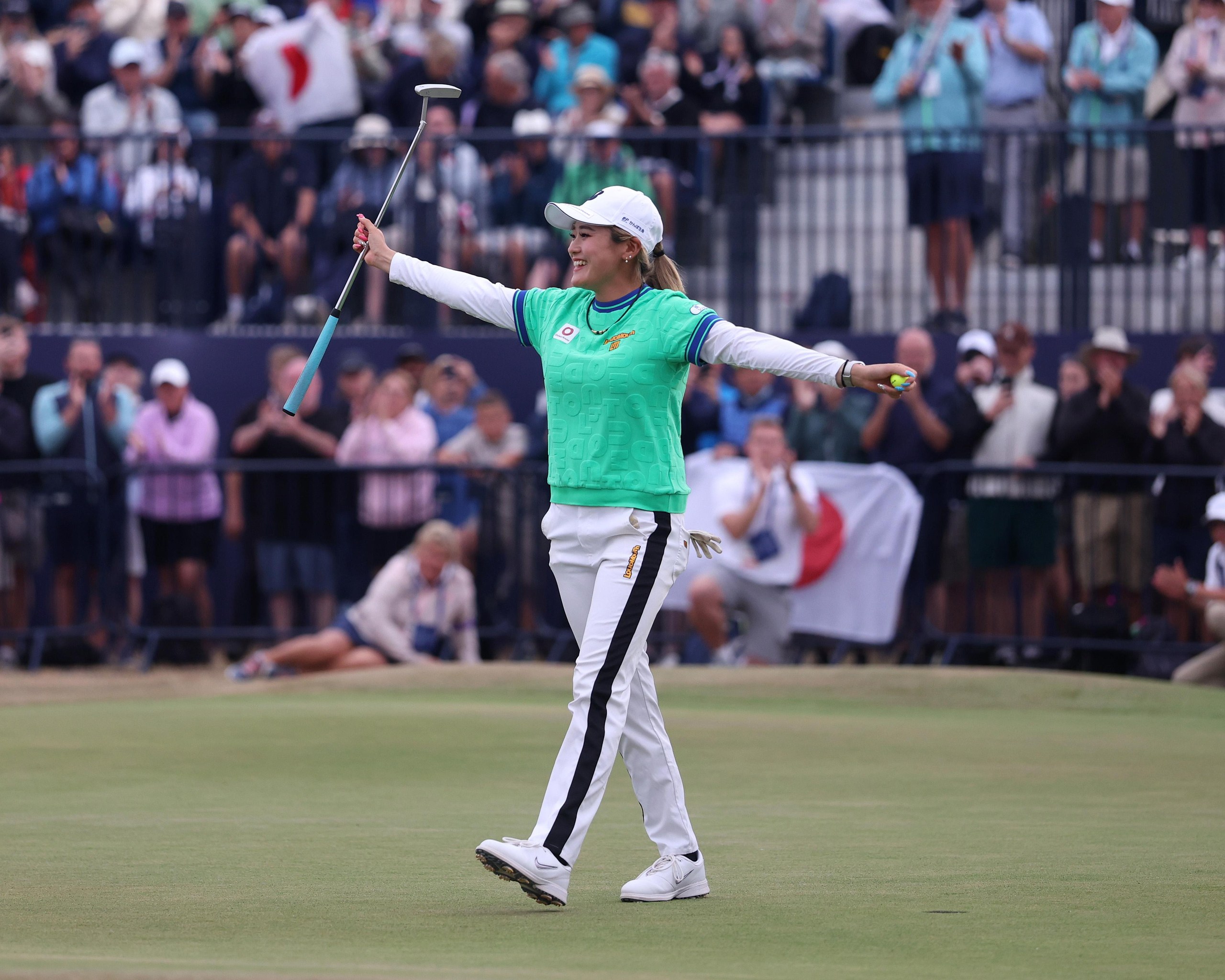 Japanese golfer Shiho Kuwaki, arms aloft, celebrates victory at Royal Lytham & St Annes