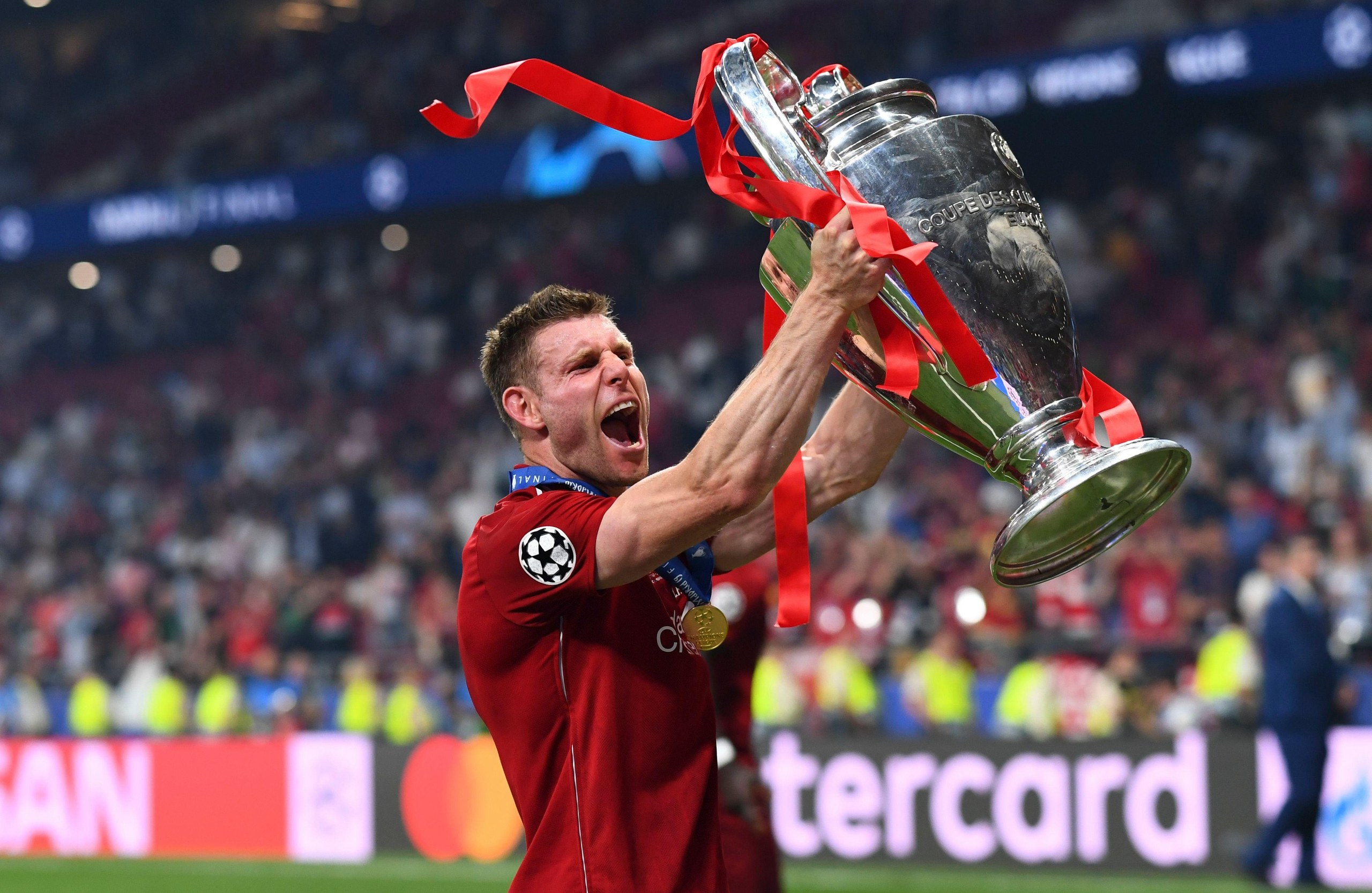 James Milner lifts the Champions League trophy after winning the competition with Liverpool in 2019