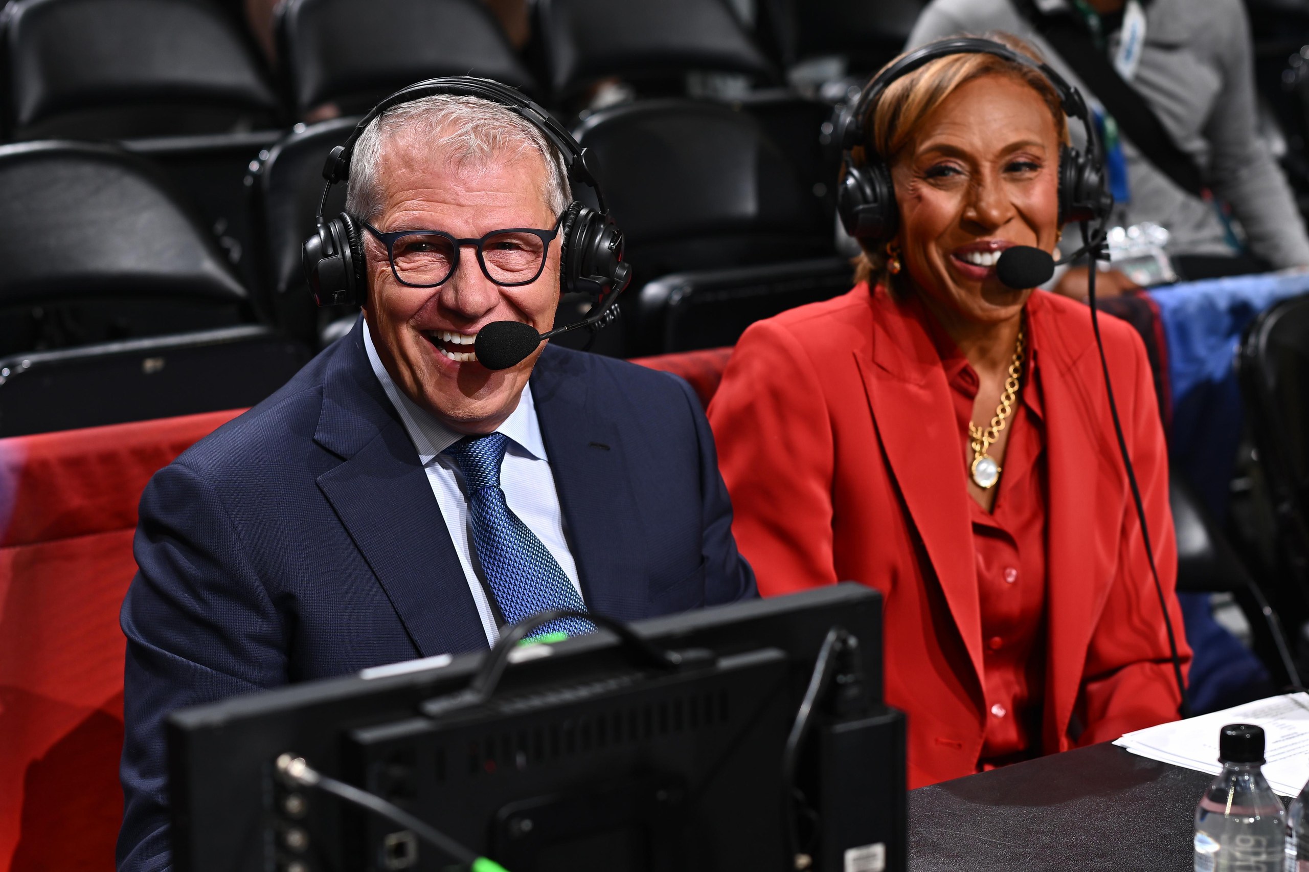 Geno Auriemma and Robin Roberts wear headsets as they prepare to broadcast a game.