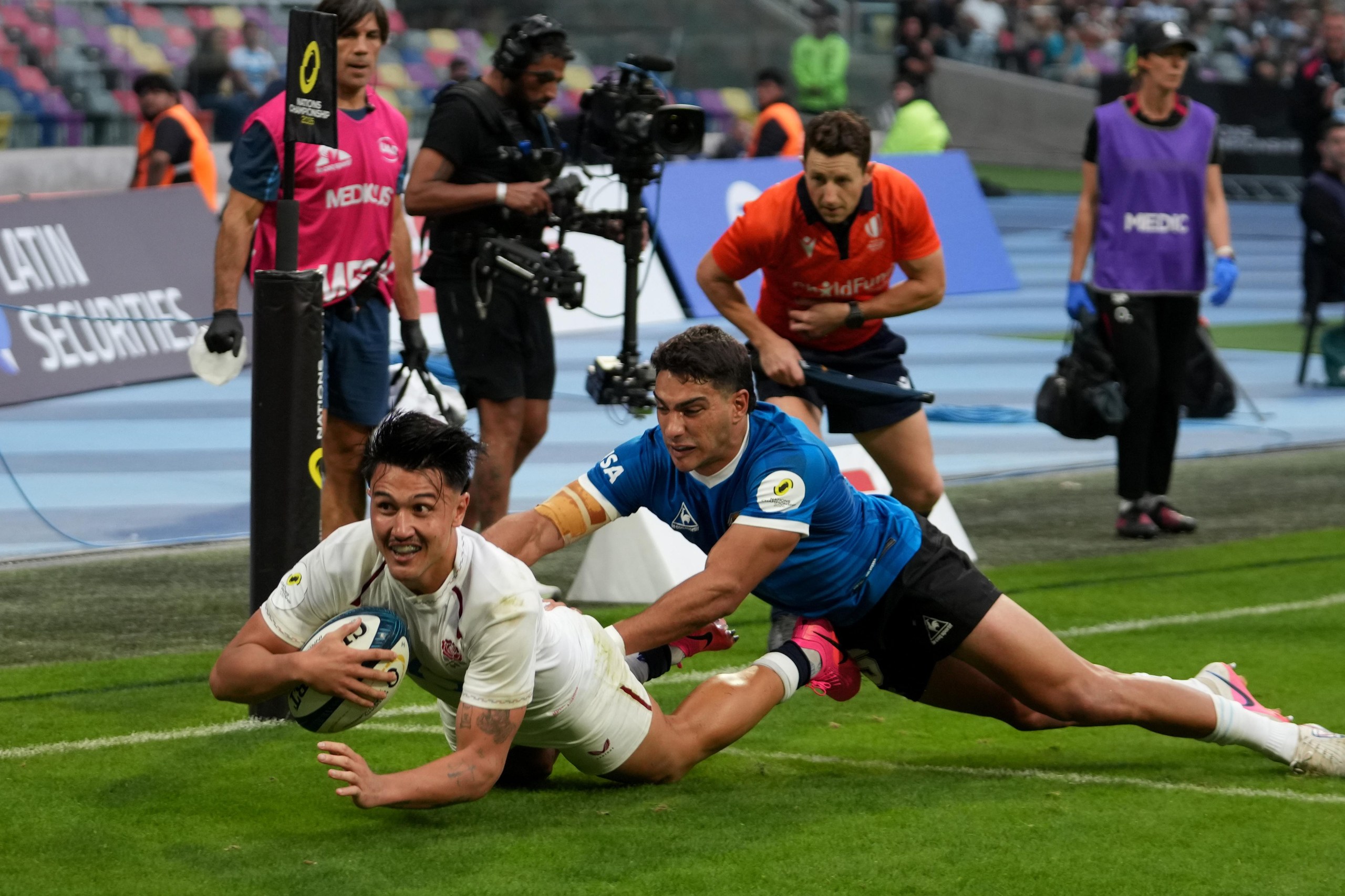 Marcus Smith of England dives in to score his team's fourth try as he is tackled by Santiago Carreras of Argentina.