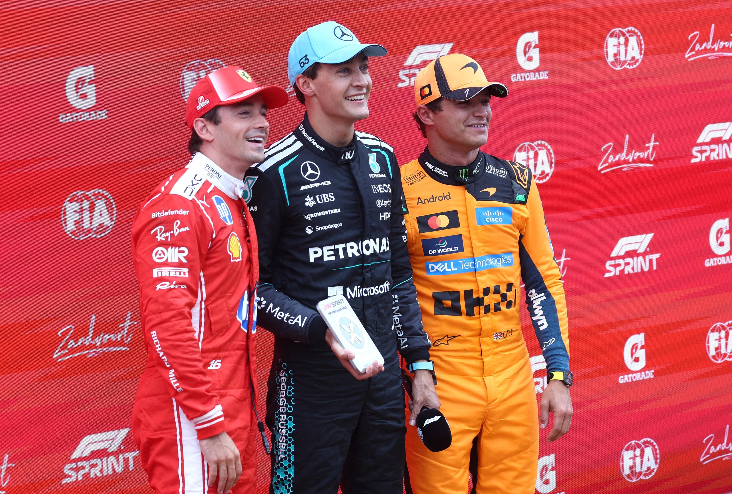 George Russell enjoys his sprint win flanked by second-place Charles Leclerc (left) and Lando Norris who finished third.