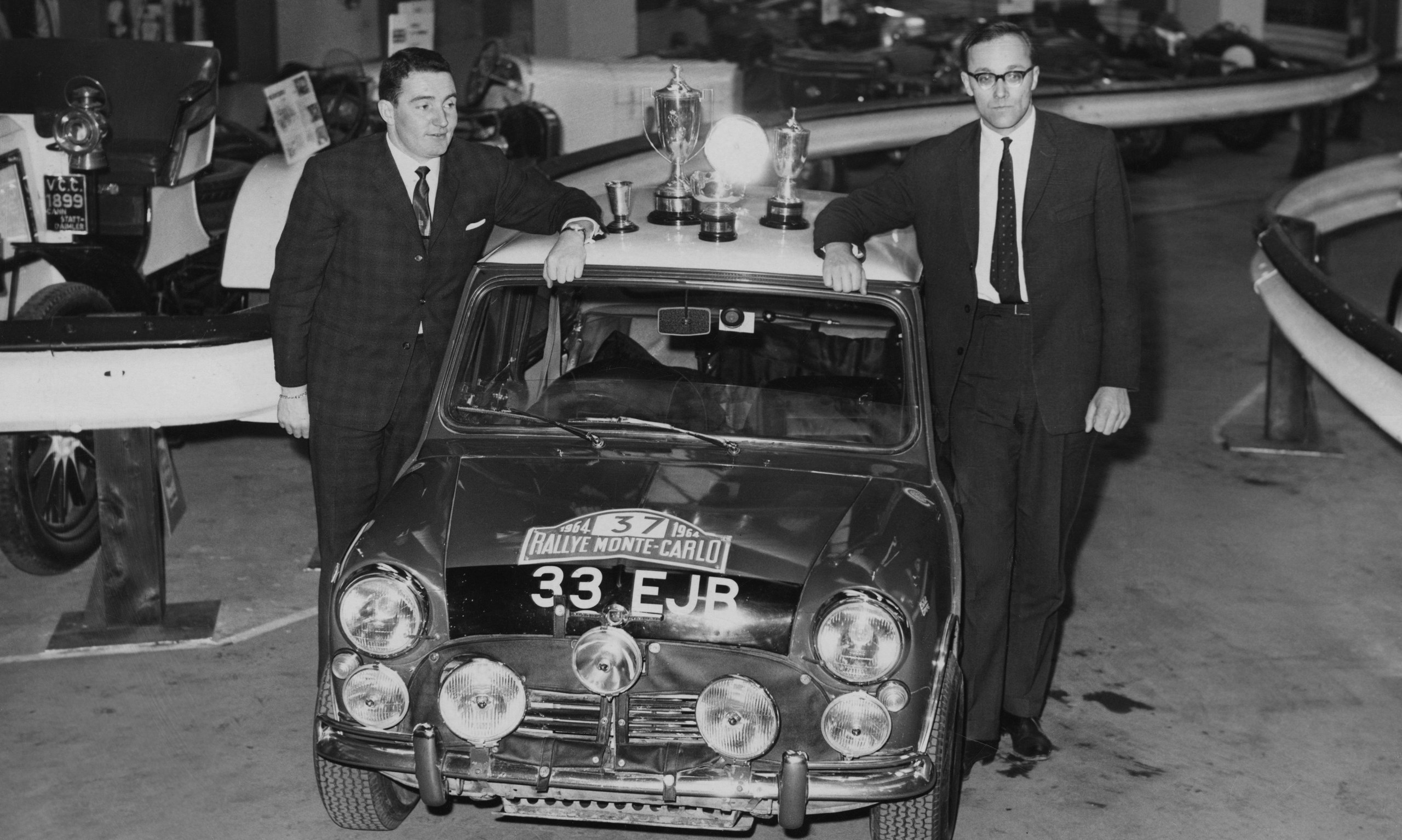 Paddy Hopkirk, left, with navigator Henry Liddon at Olympia in London in 1964, showing off the Mini Cooper in which they had just won the Monte Carlo Rally.