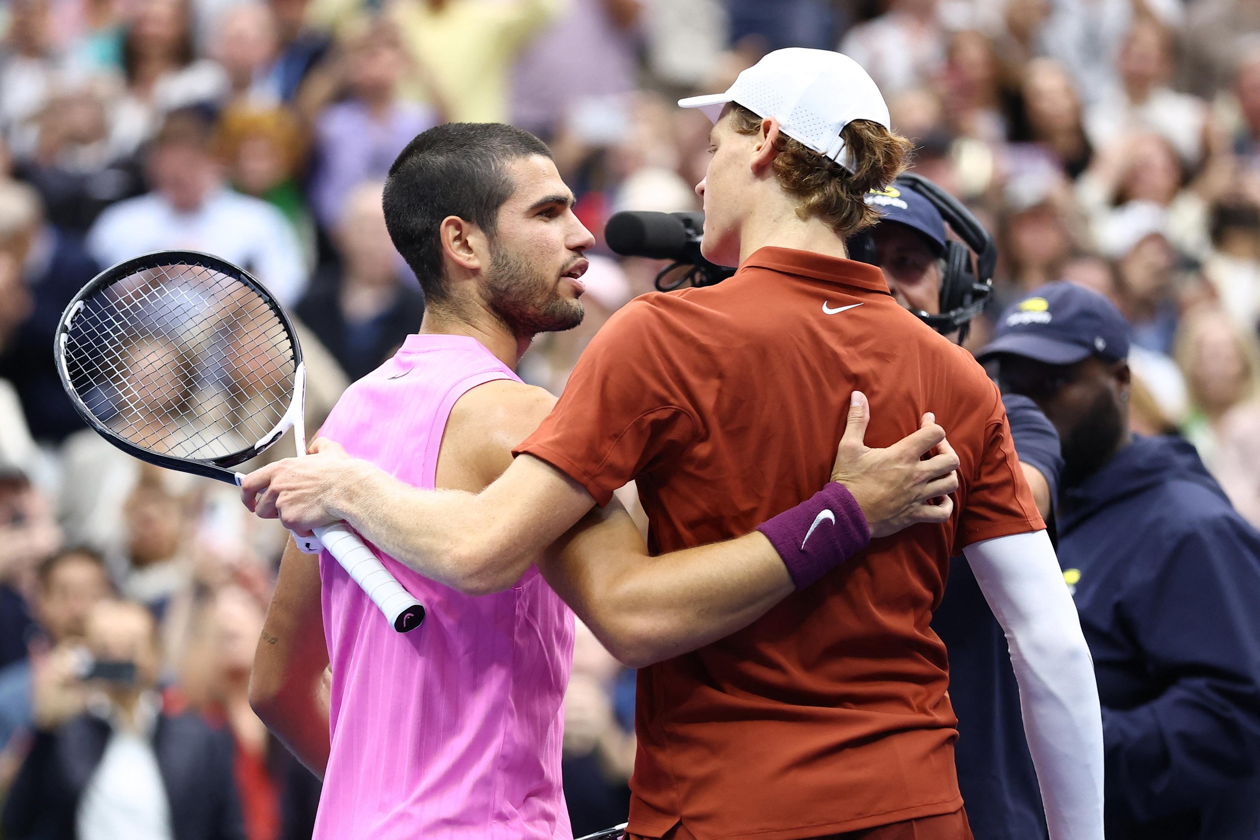 Carlos Alcaraz and Jannik Sinner greet each other at the net at the conclusion of their match