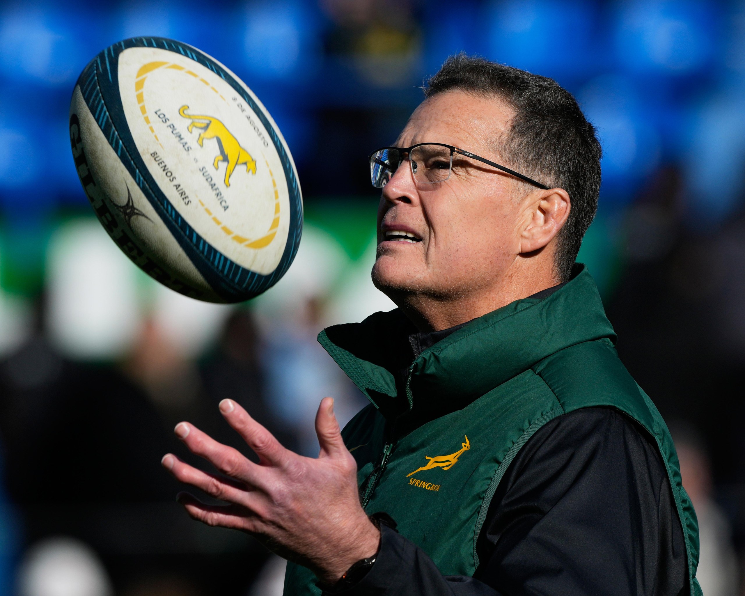South Africa head coach Rassie Erasmus tosses a rugby ball