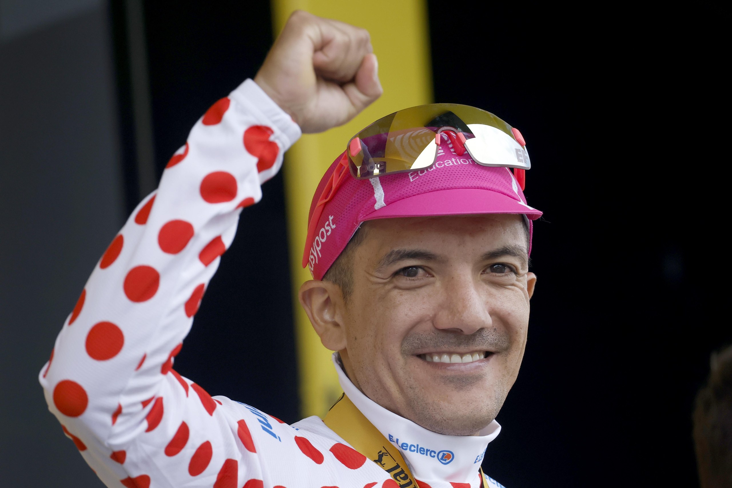 EF Education - EasyPost’s Richard Carapaz celebrates on the podium wearing the best climber’s polka dot jersey after winning Stage 20.