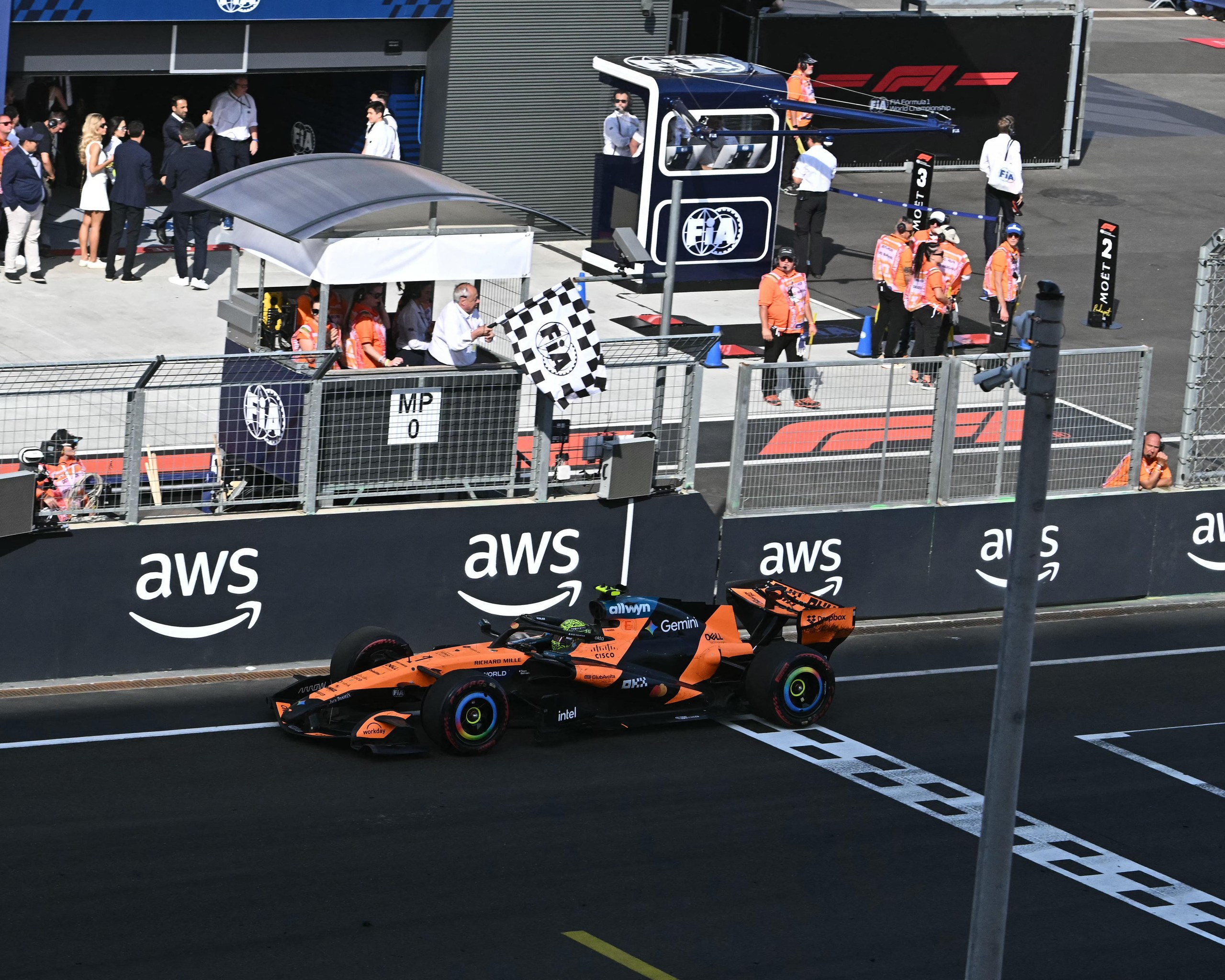 McLaren's British driver Lando Norris drives through the finish line to win.