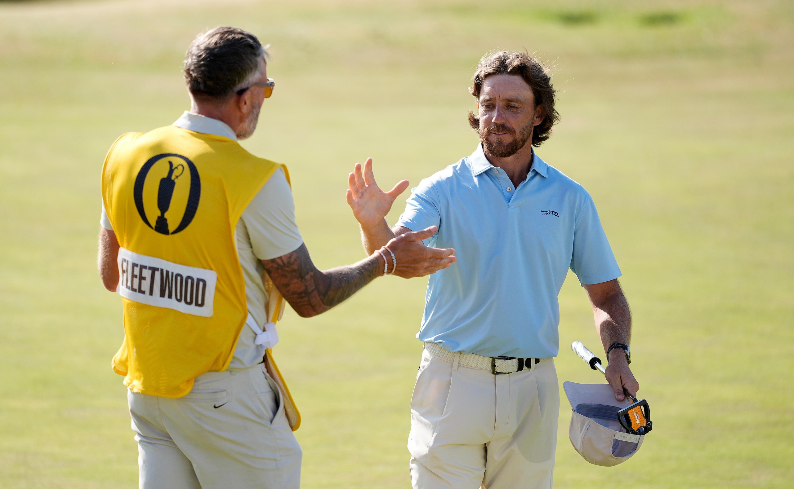 Tommy Fleetwood of England (left) and caddie Ian Finnis embrace on the 18th green.
