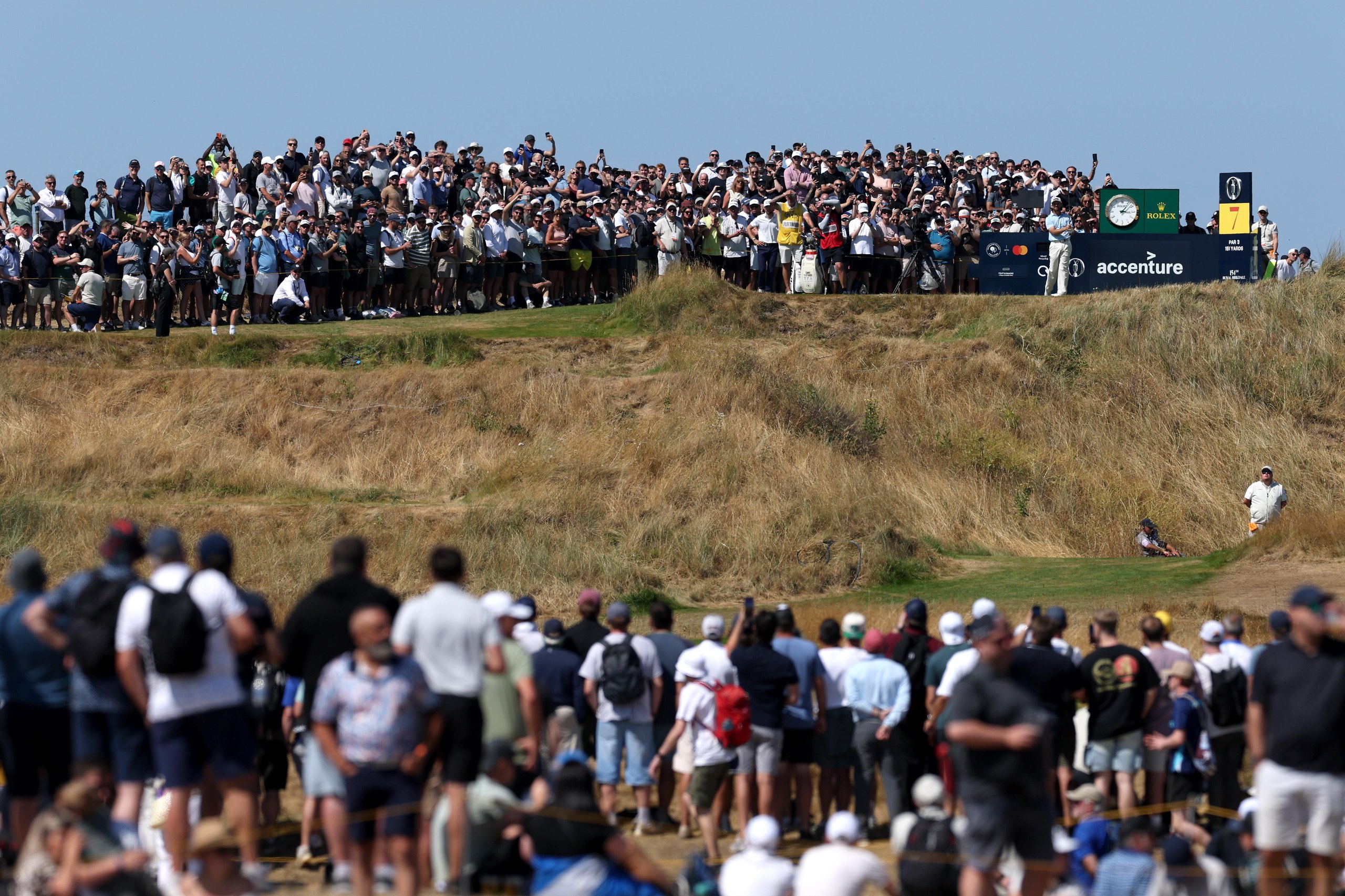 Tommy Fleetwood tees off in front of a large crowd.