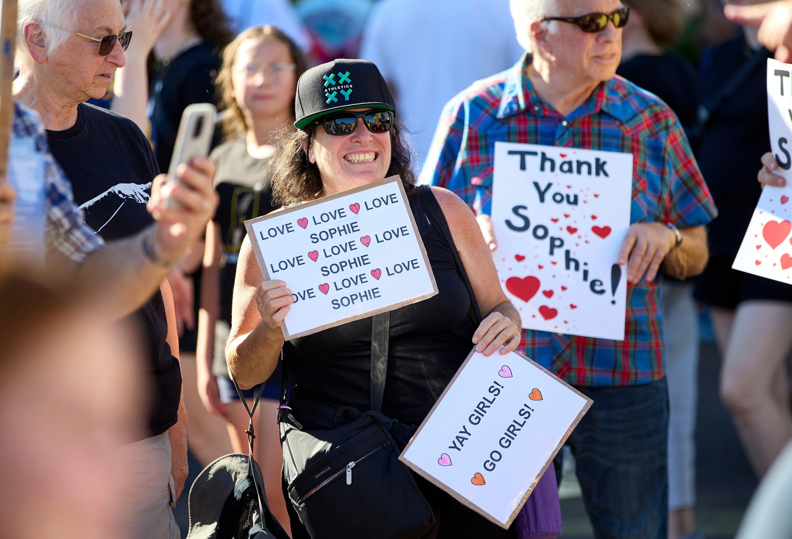 People rally to support Sophie Cunningham after her comments on transgender athletes in women’s sports before a game between the Fever and Fire in Portland on Friday night.