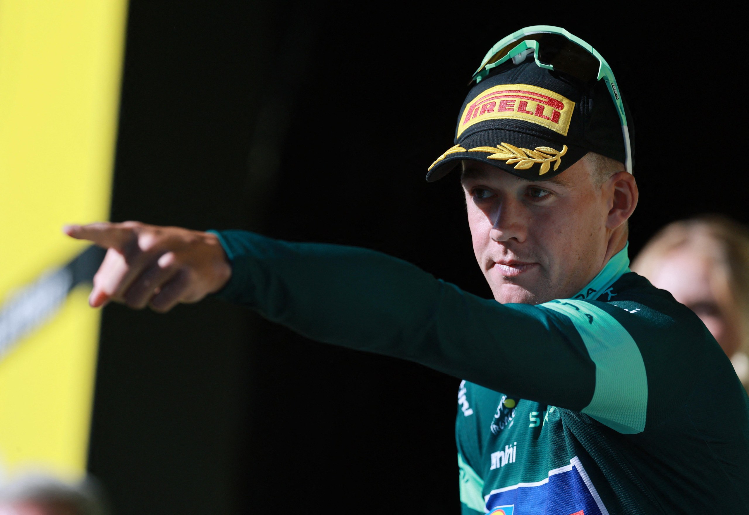 Lidl - Trek's Mads Pedersen celebrates on the podium wearing the green jersey after stage 19.