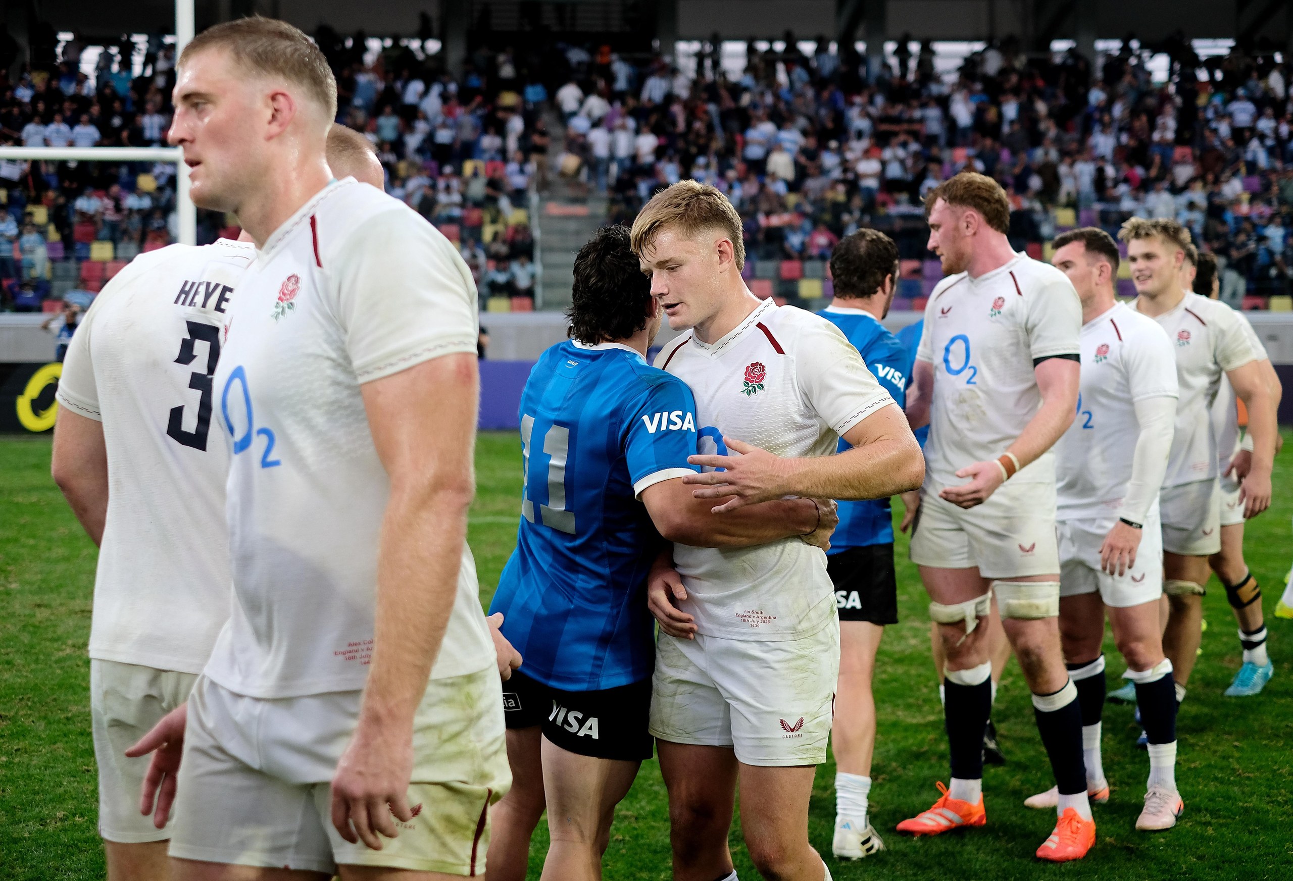 Fin Smith and England shake hands with Argentina players.