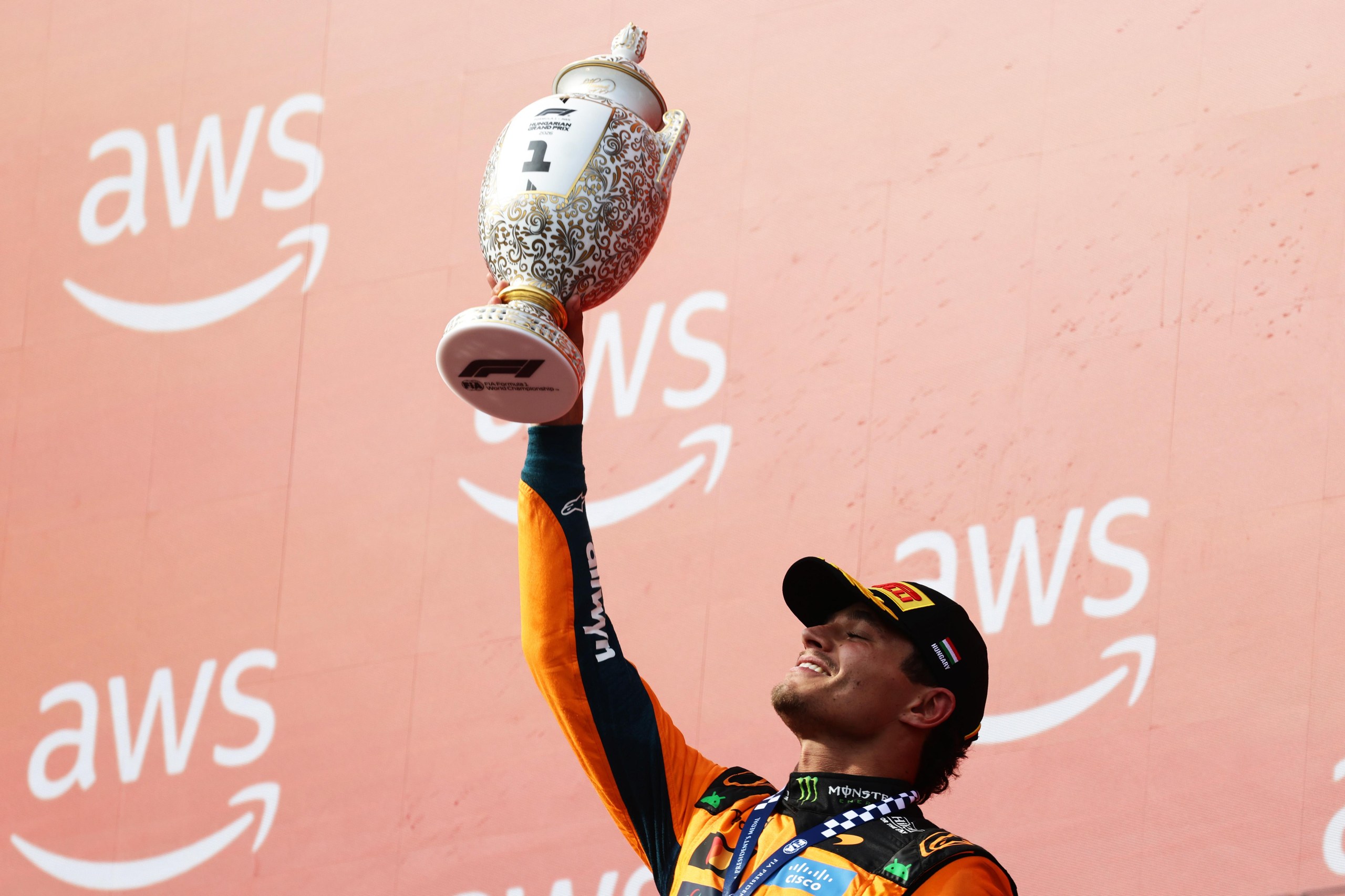 Norris lifts the trophy.