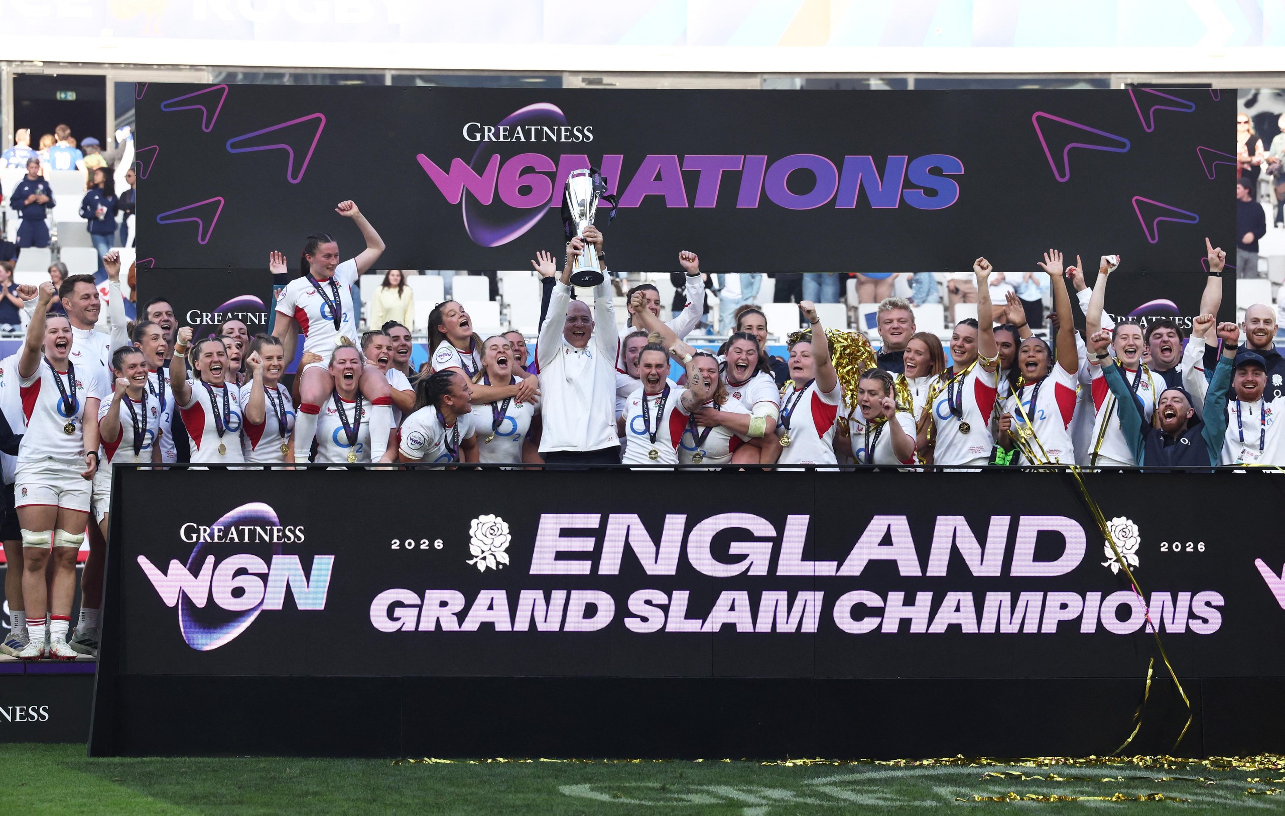 England's head coach John Mitchell lifts the trophy as he celebrates winning the Women’s Six Nations Championship with his players.