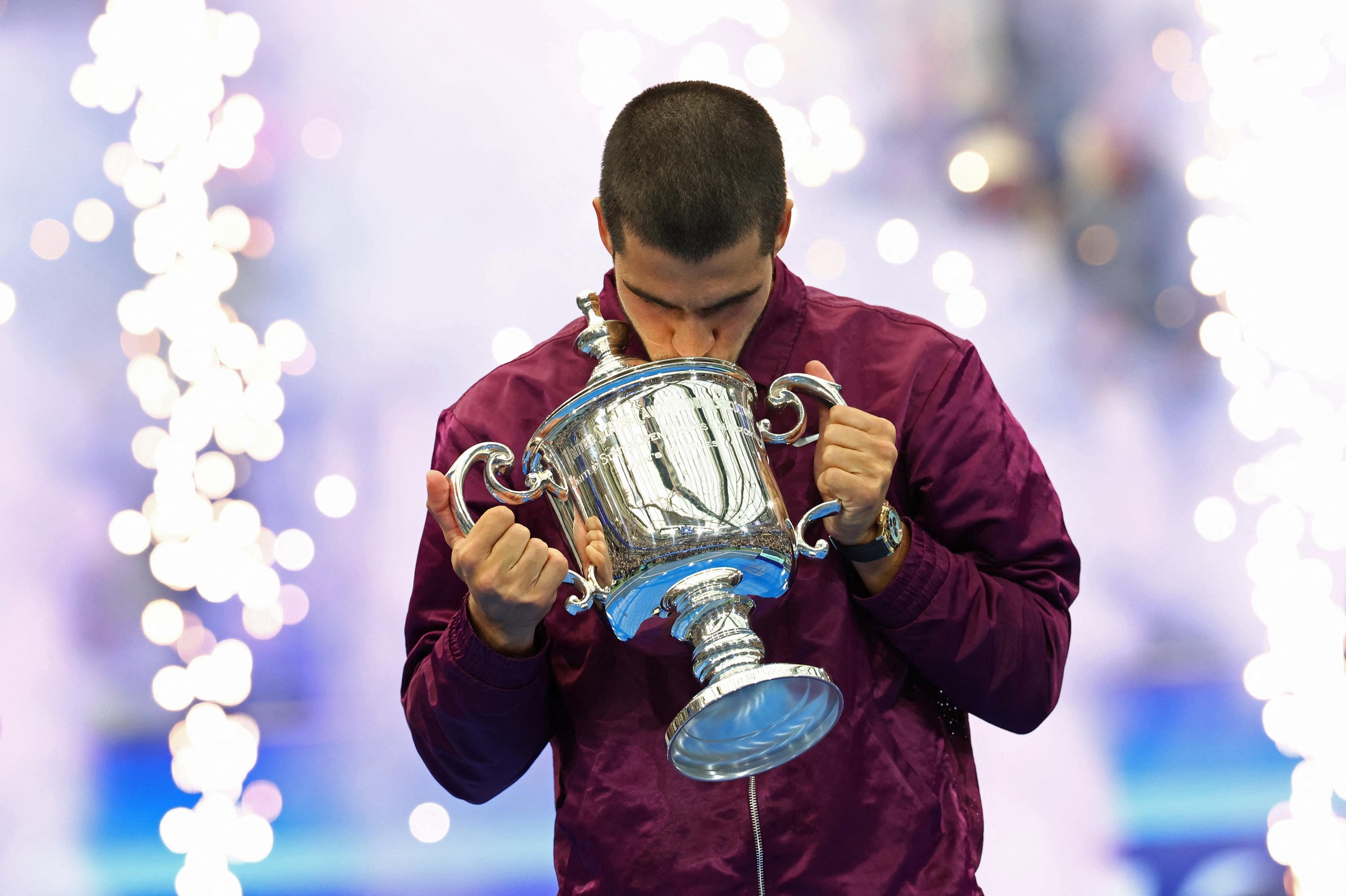 Alcaraz celebrates with the trophy.