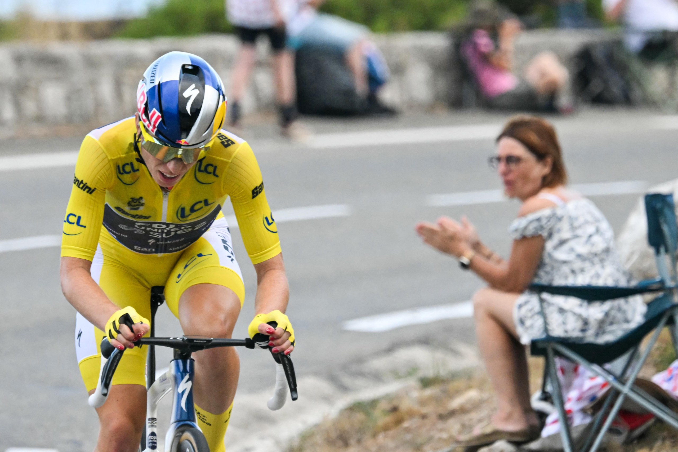 Demi Vollering wearing the overall leader's yellow jersey