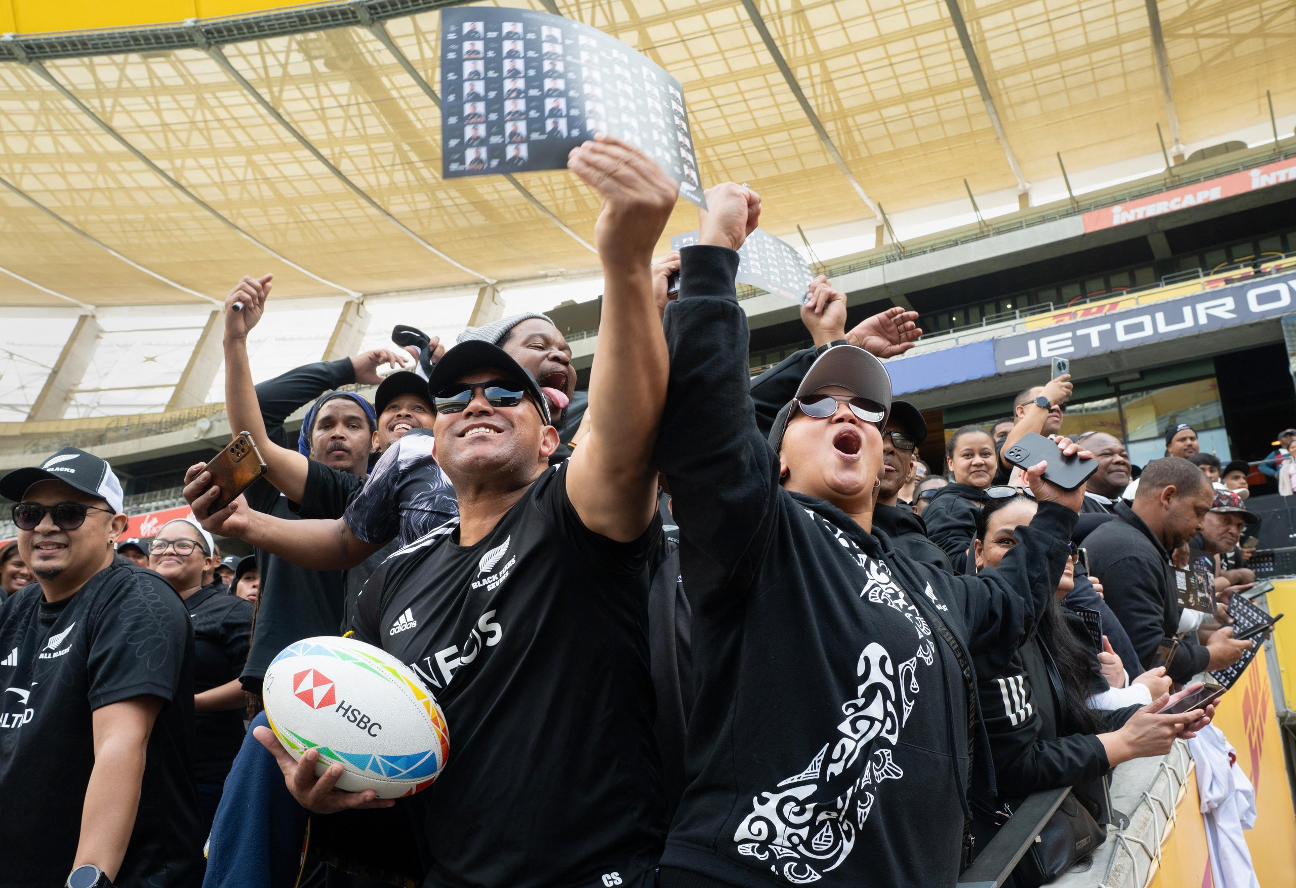 All Blacks fans cheer during an event to mark the team’s arrival in Cape Town