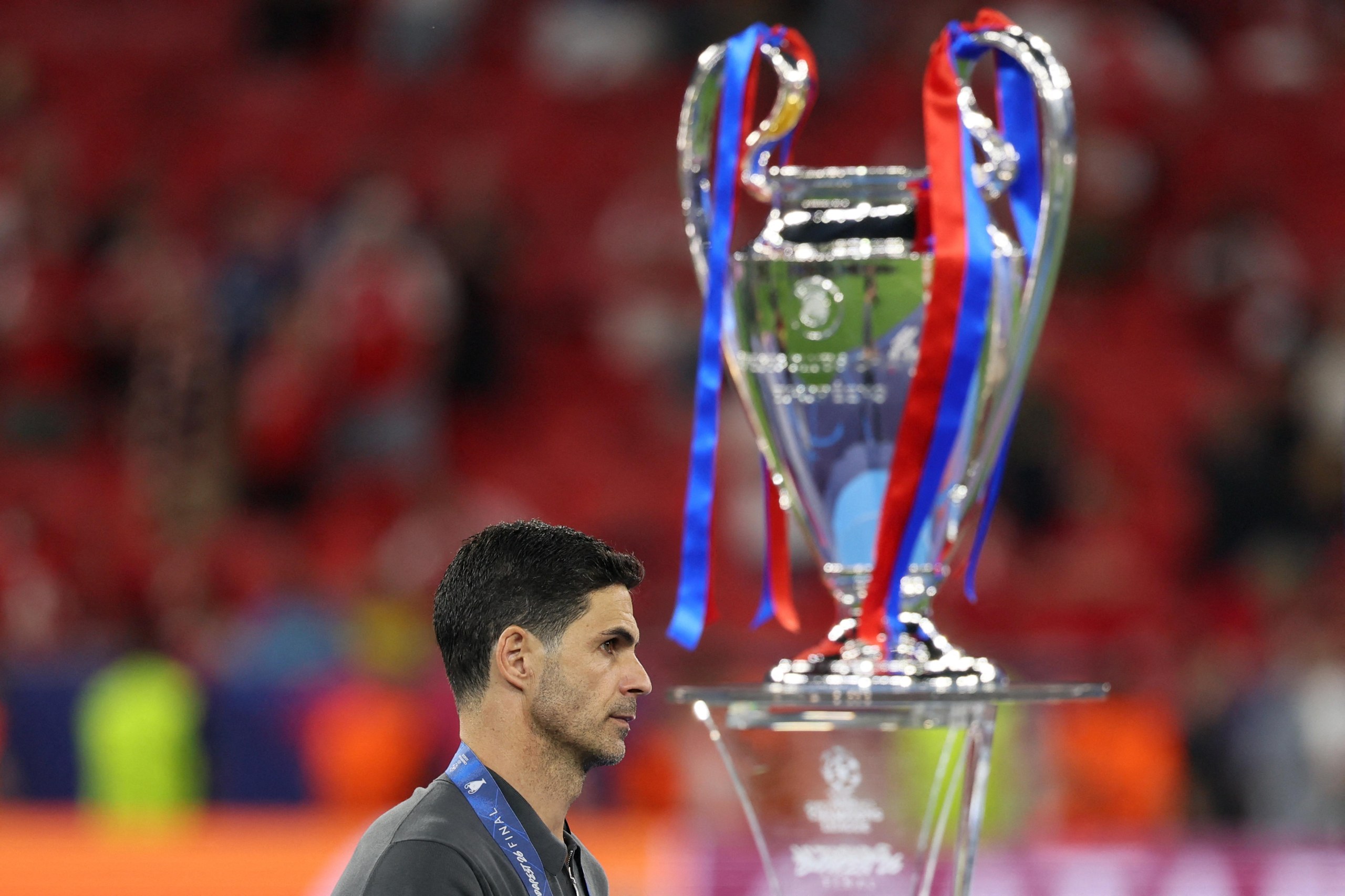 Arsenal’s Mikel Arteta walks past the trophy.