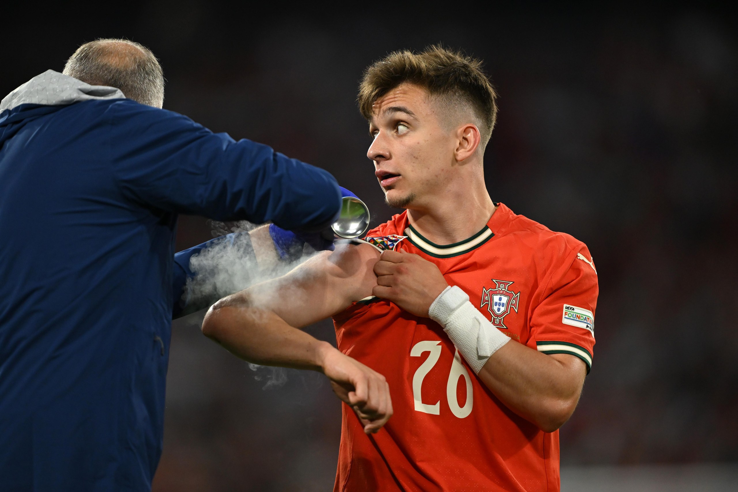 Francisco Conceicao of Portugal is treated by medical staff during the Nations League semi-final against Germany.