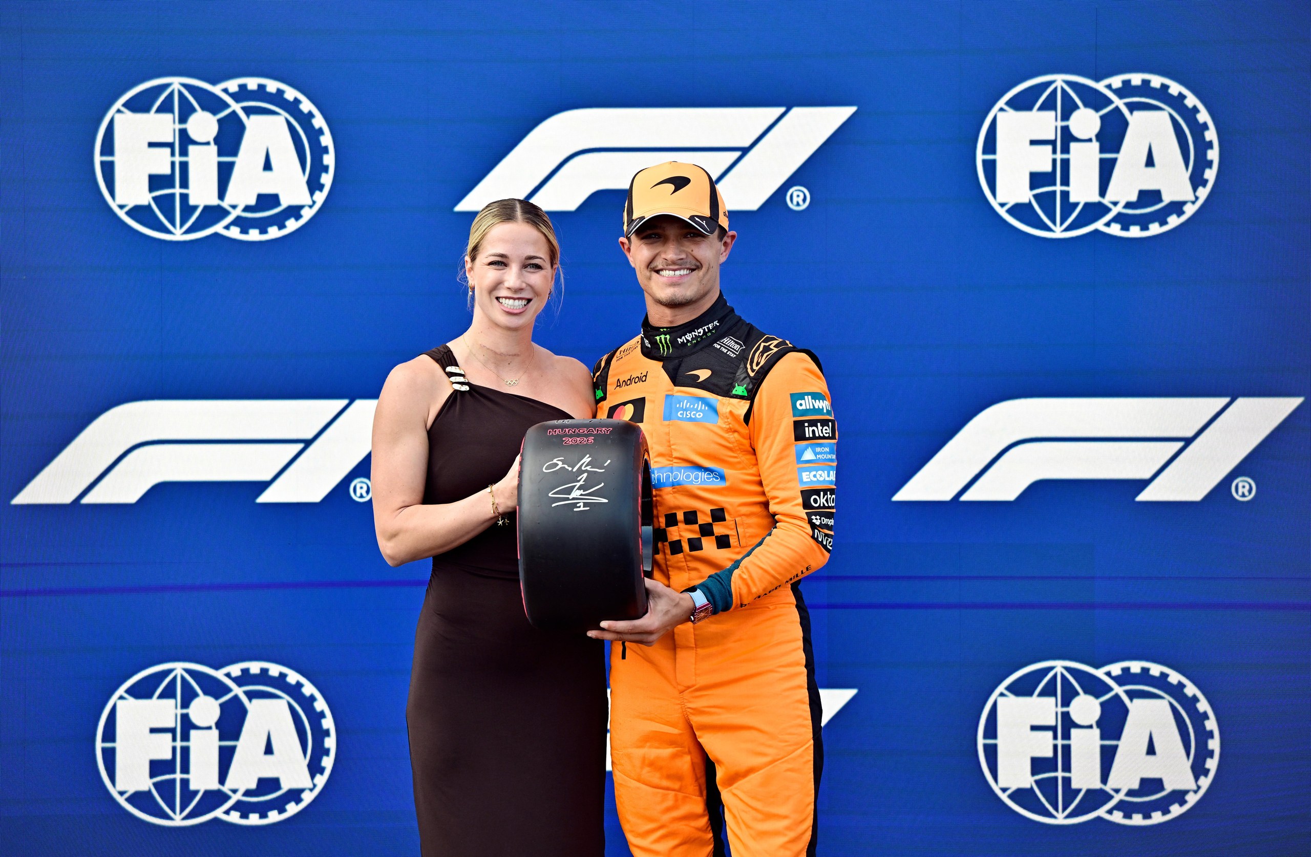 McLaren’s Lando Norris celebrates with a trophy after qualifying in pole position.