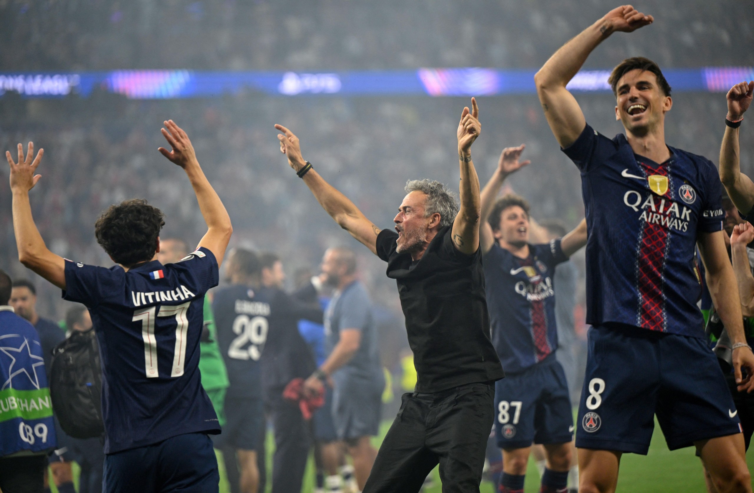 Paris Saint-Germain’s head coach Luis Enrique (centre) celebrates alongside Fabian Ruiz (right) and other team members.